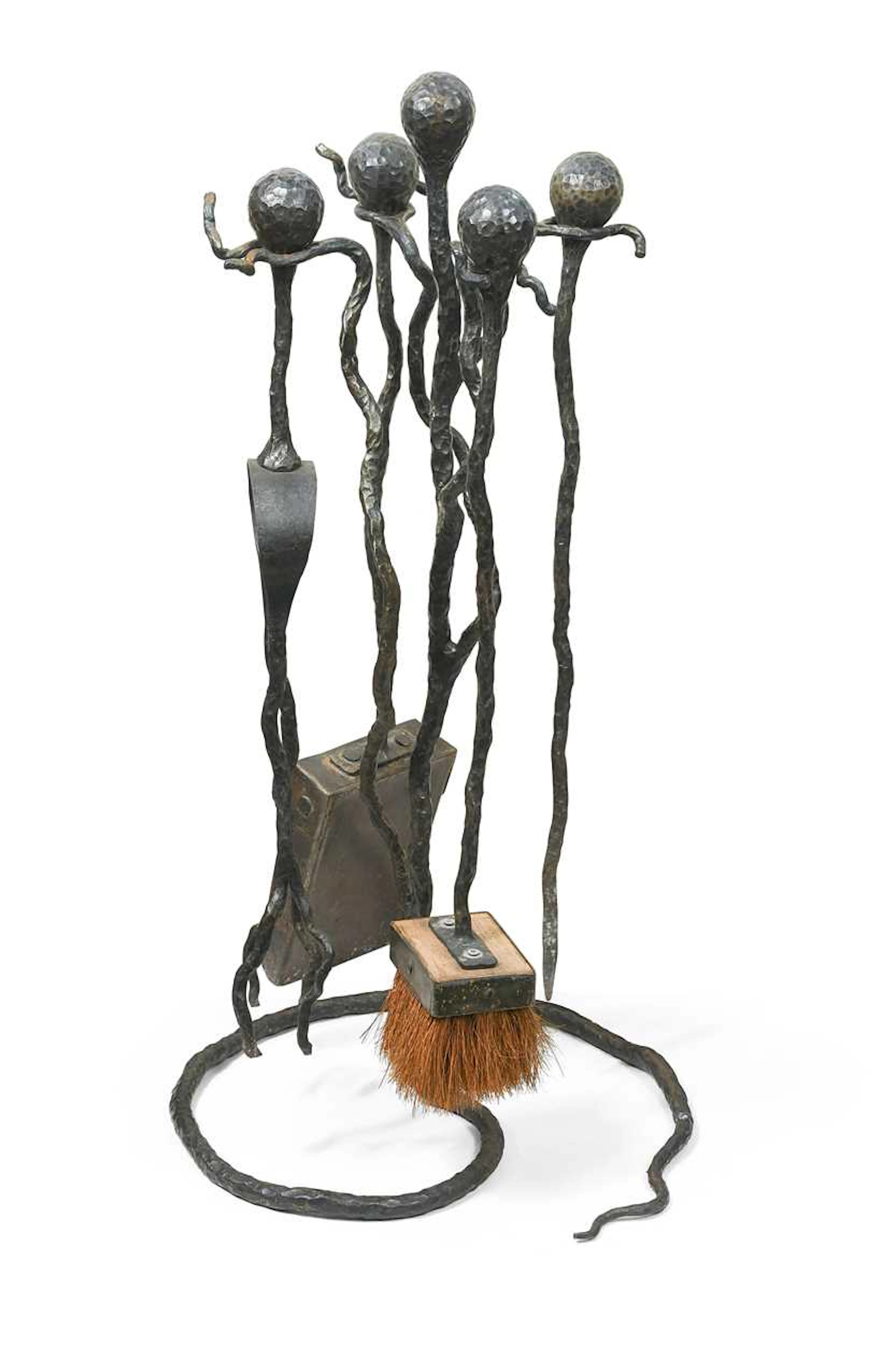A wrought iron fireside companion set, in the manner of Diego Giacometti