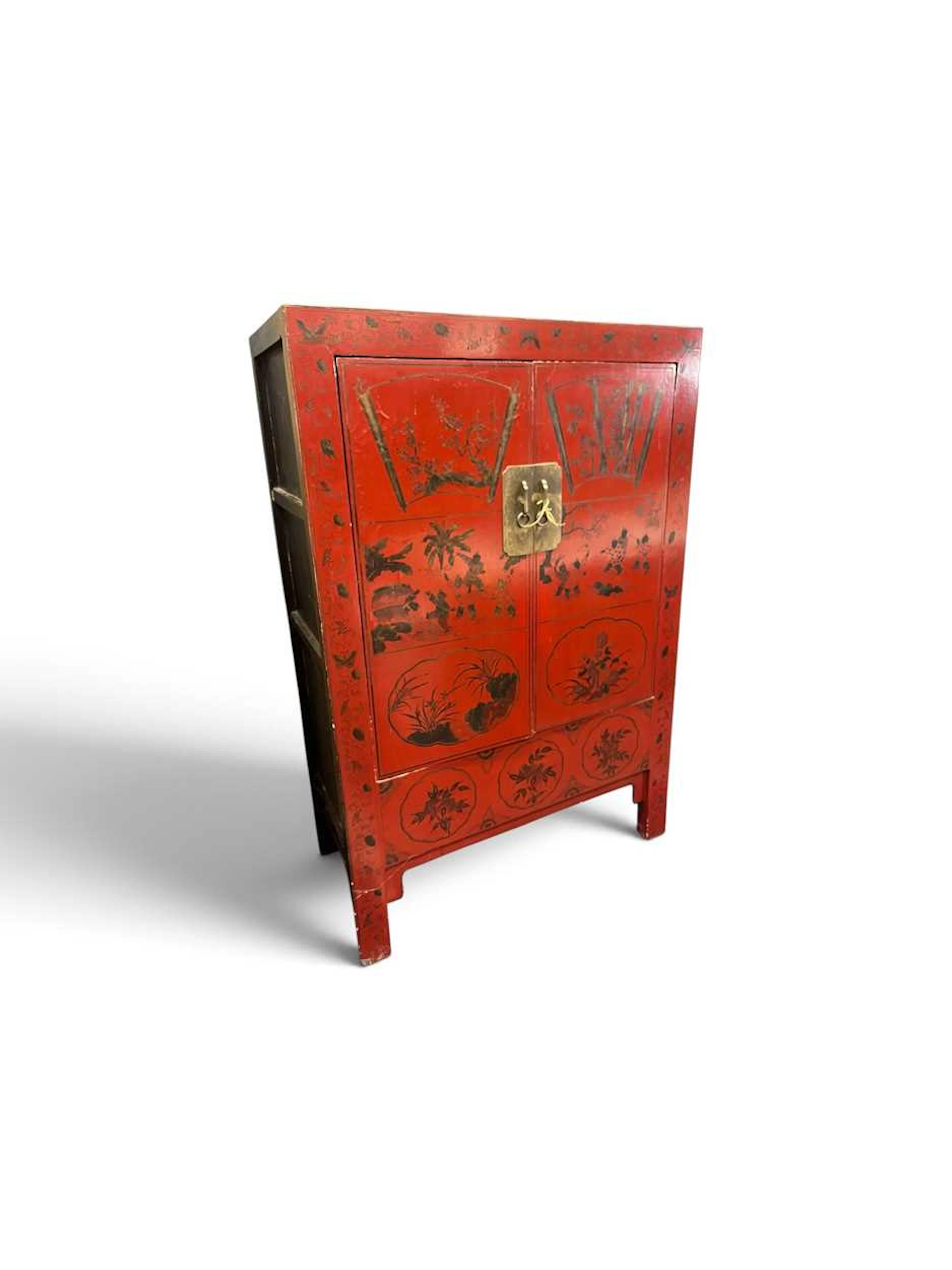 A Chinese red and gilt painted cupboard