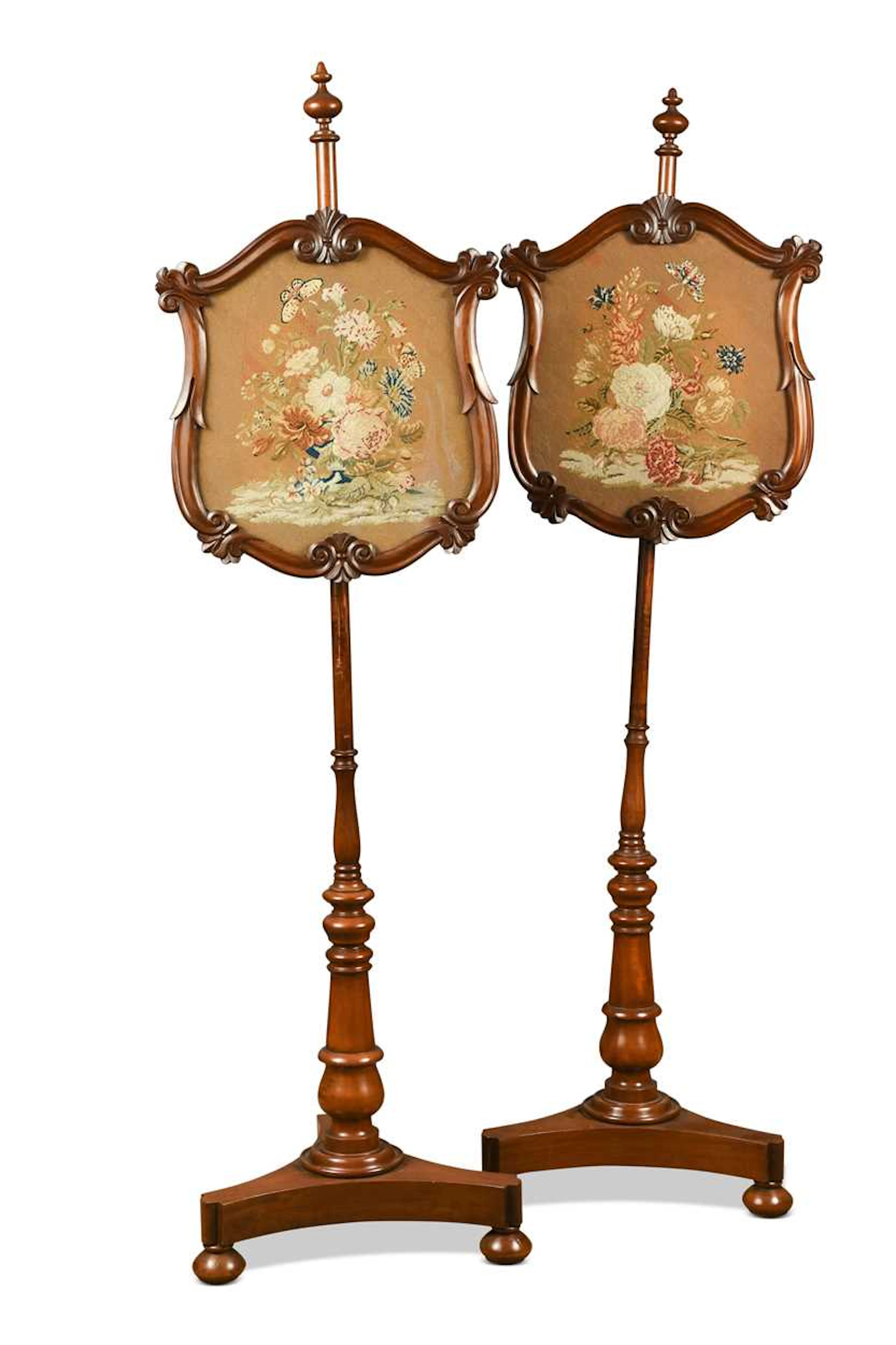 A pair of Victorian mahogany pole screens