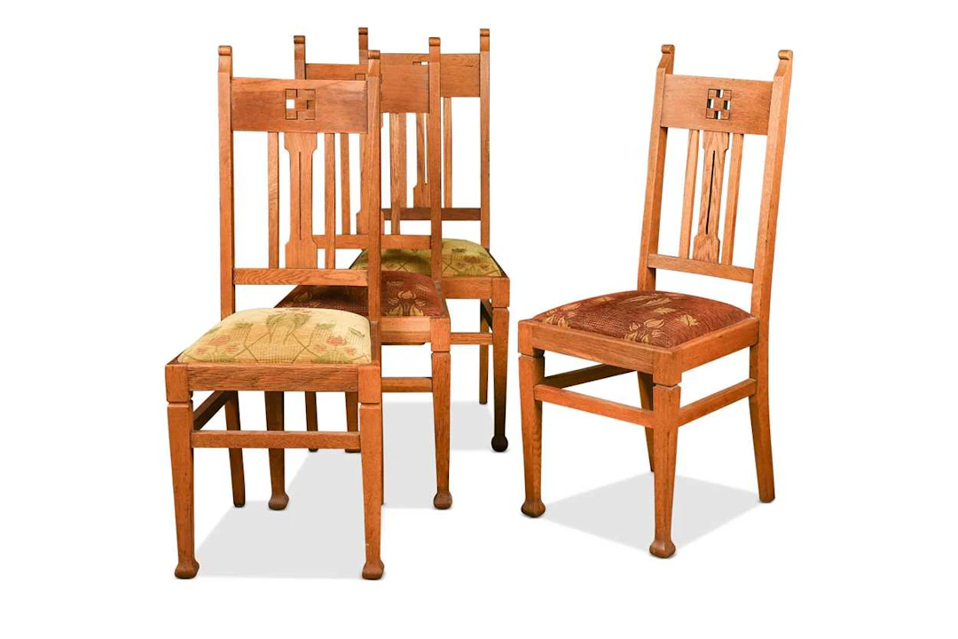 A set of four Arts & Crafts oak dining chairs