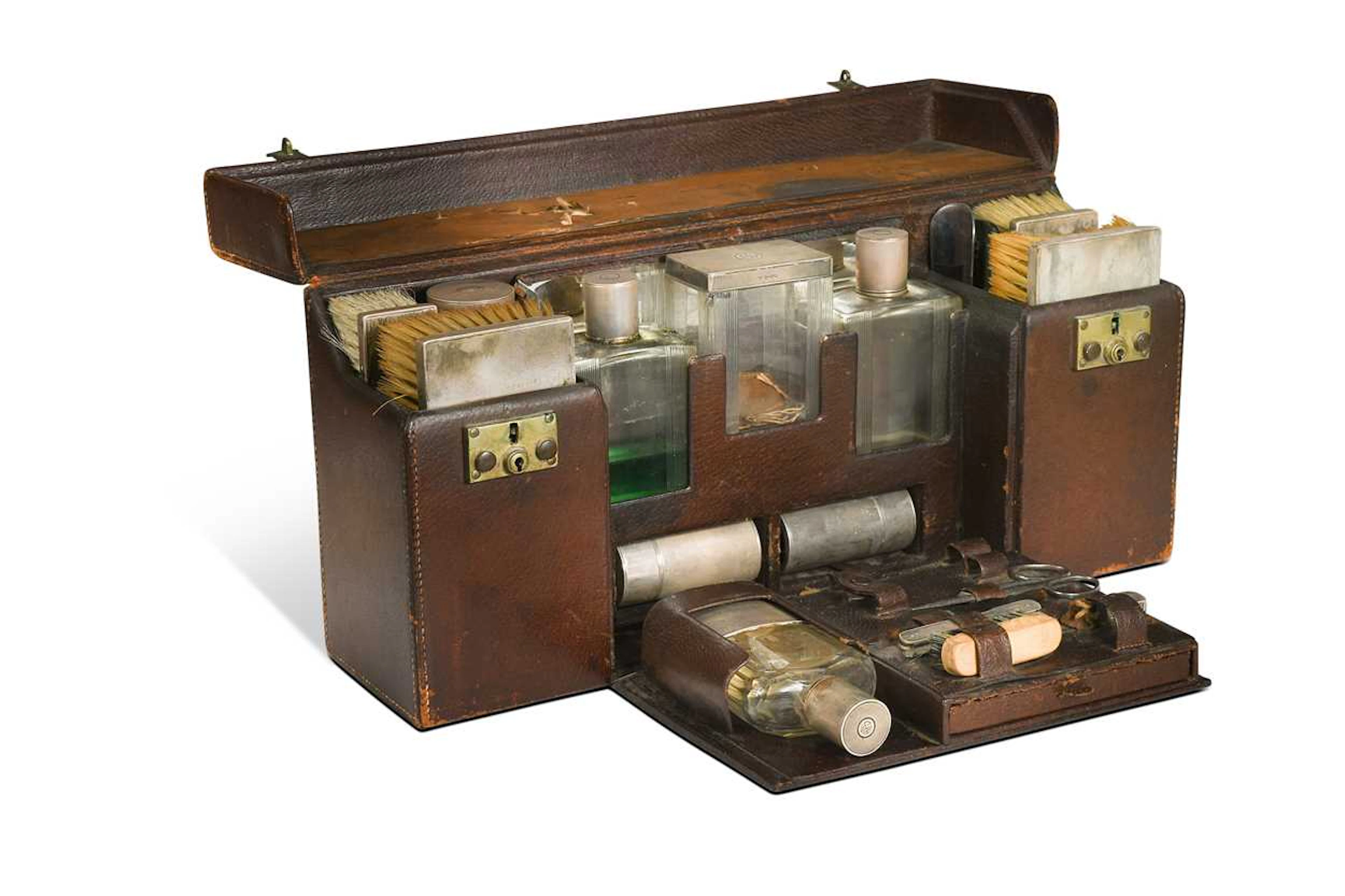 A fitted vanity case with silver-mounted contents