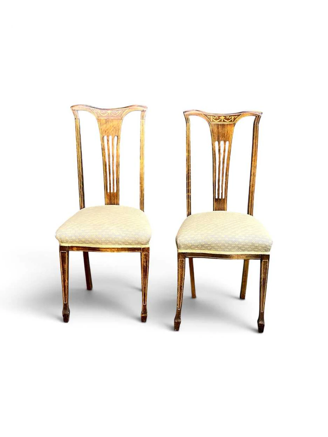 A pair of Edwardian faux rosewood and inlaid chairs