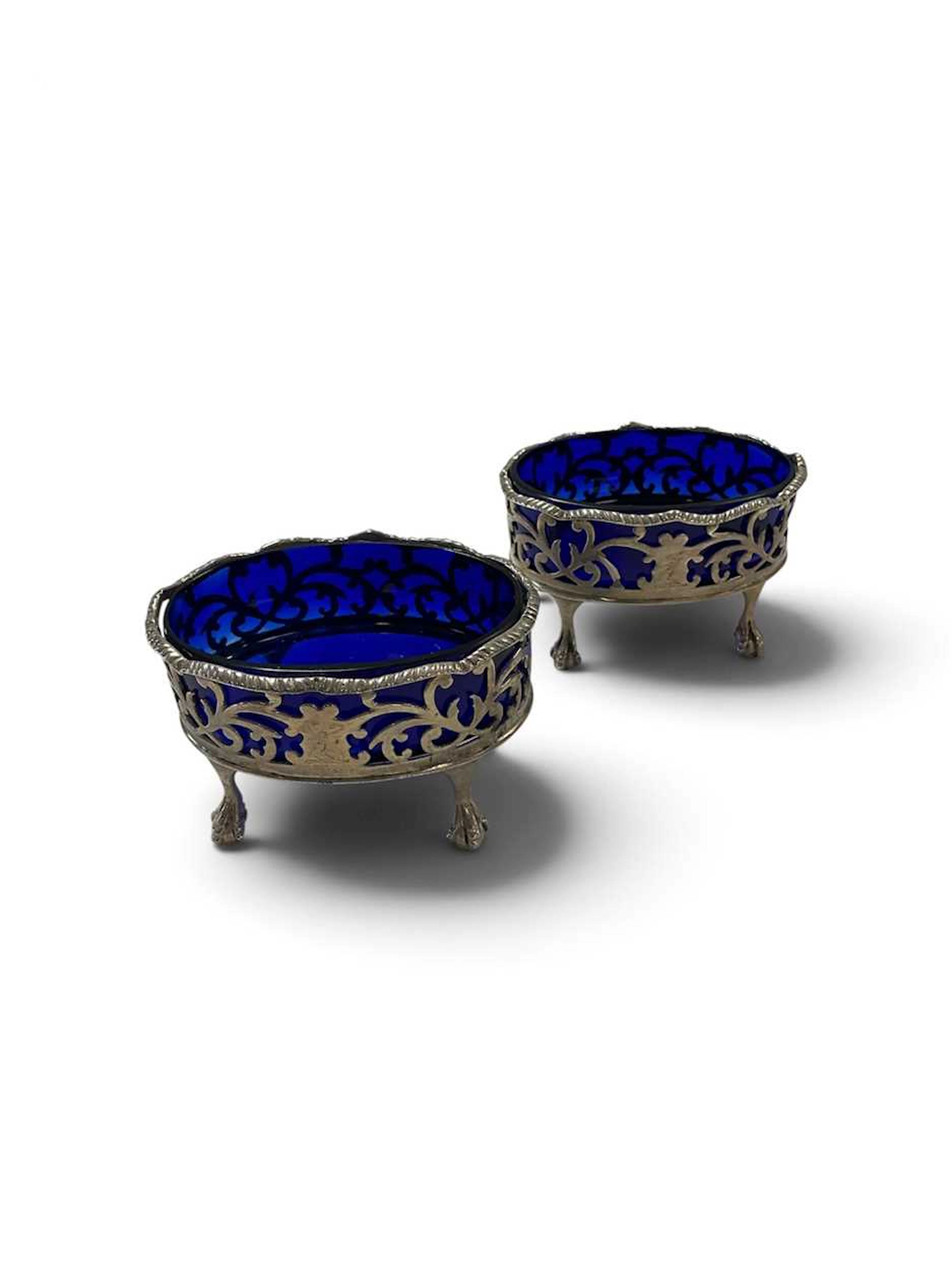 A pair of salts with blue glass liners