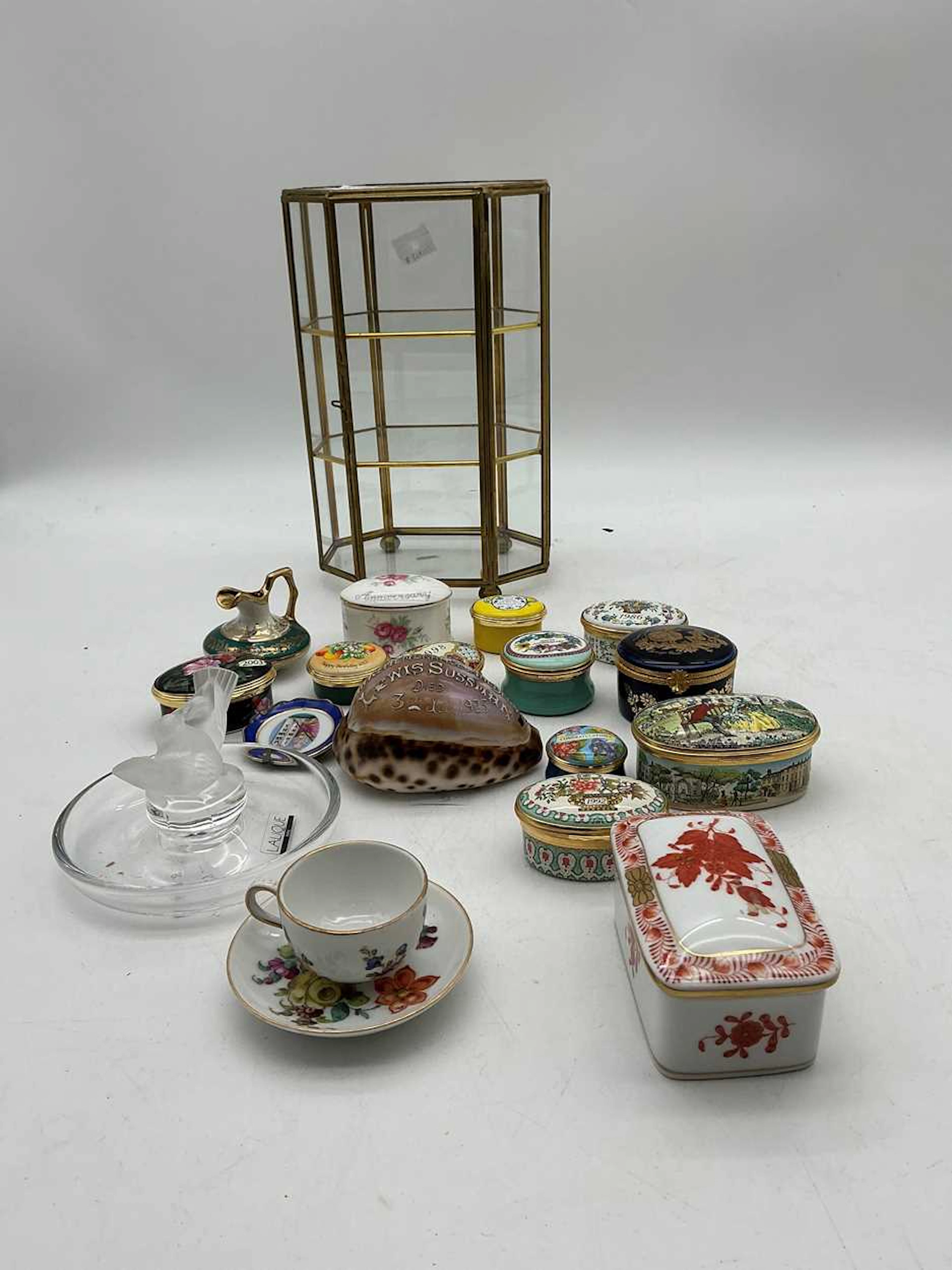 A small octagonal brass and glass display cabinet...