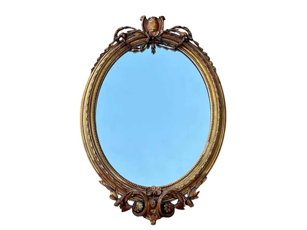 A 19th century oval gilt framed wall mirror (losses) 84 x 56cm