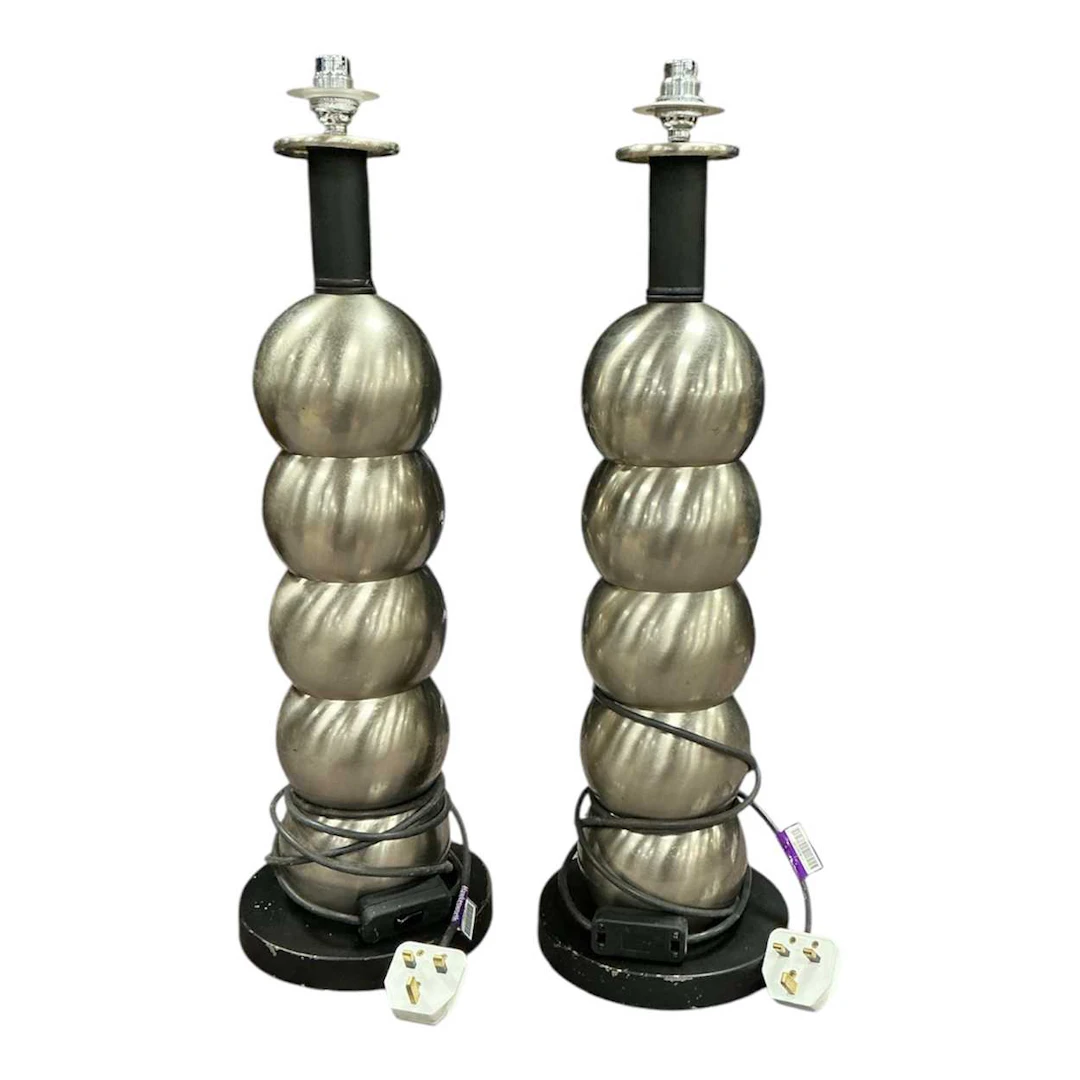 Pair of spun metal bobble lamps on turned black bases