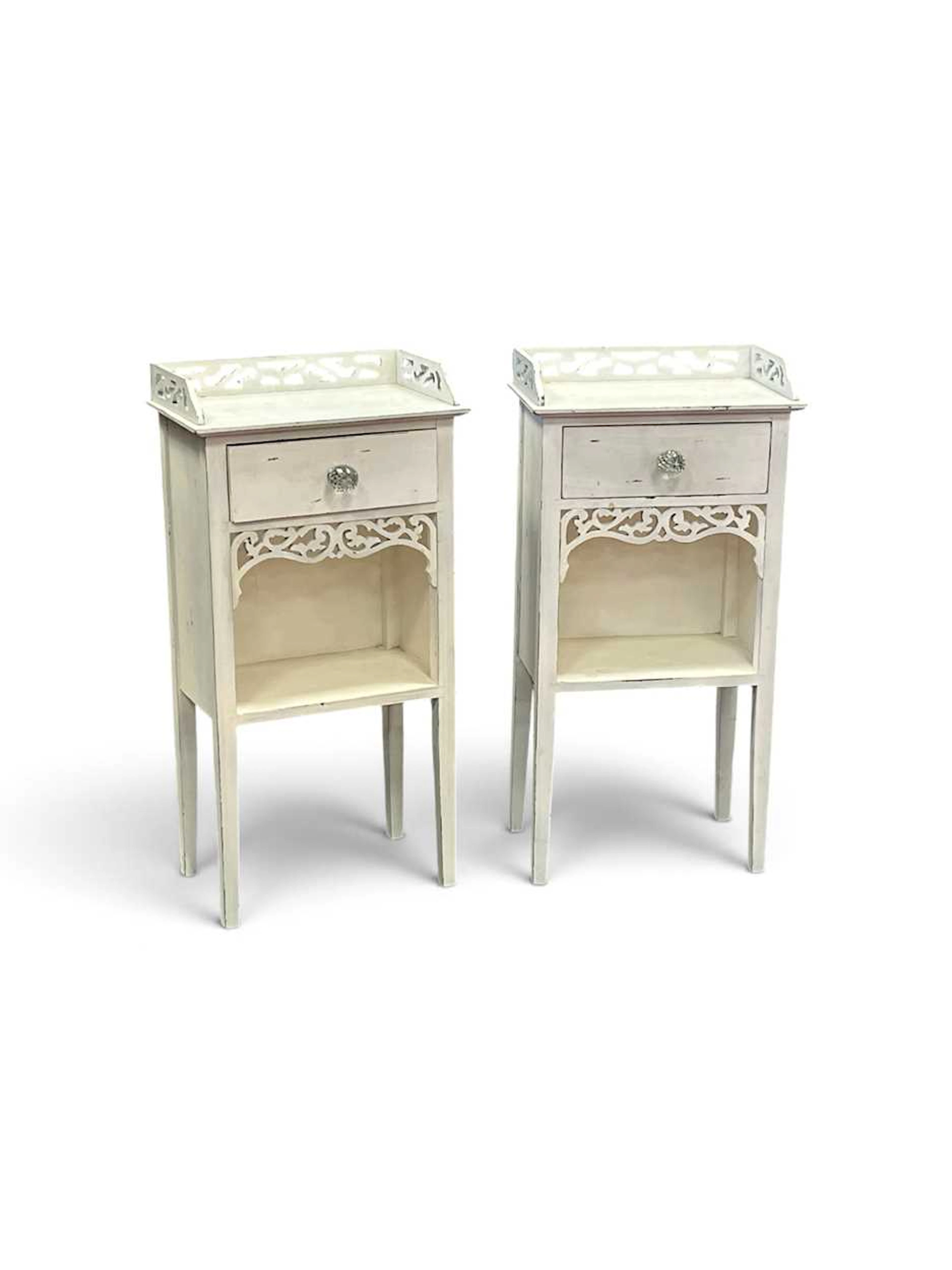 A pair of white painted bedside tables