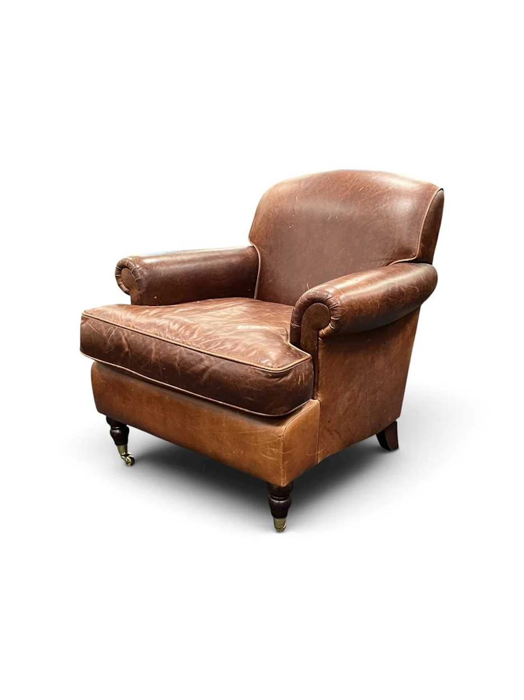 A brown leather upholstered armchair