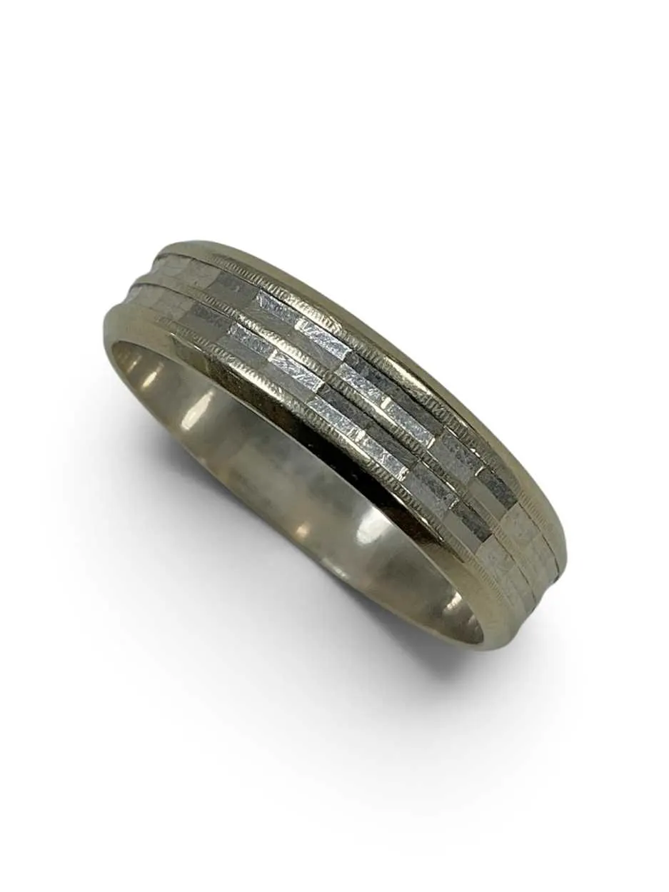 A white gold wedding band with diamond cut detail