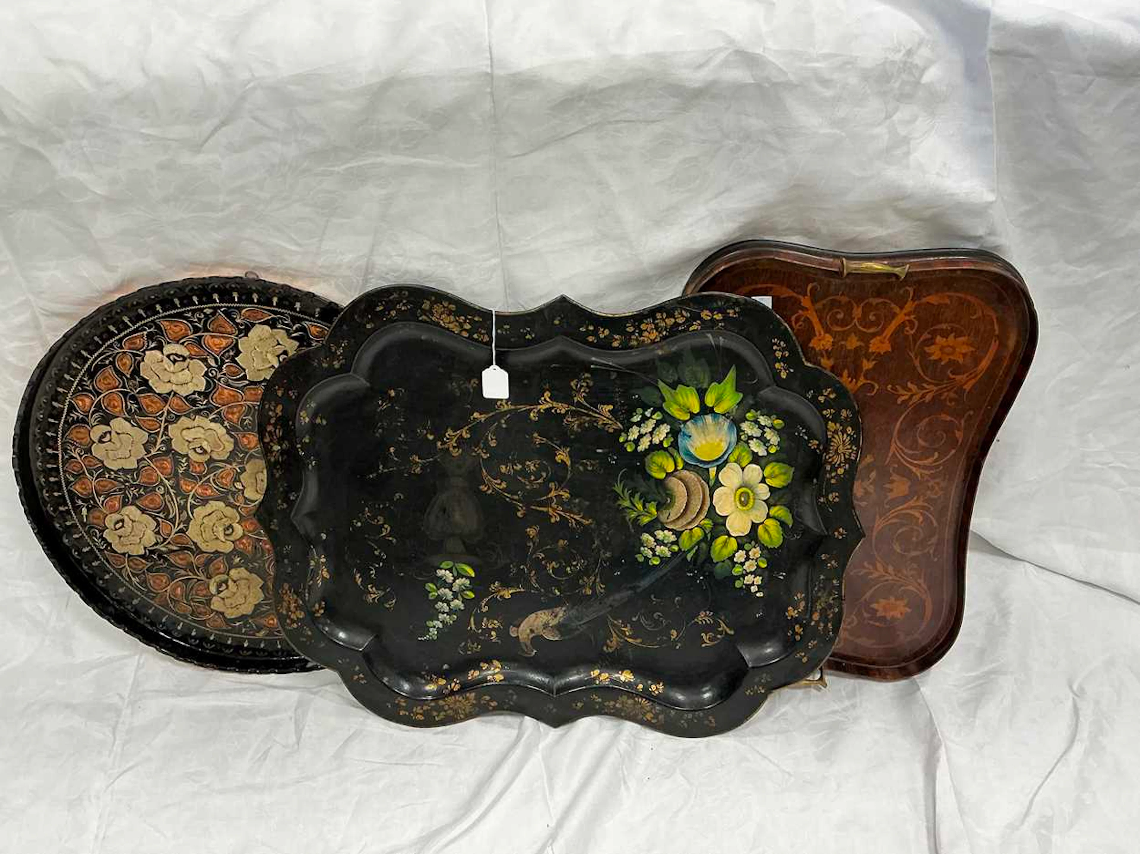 A Victorian tole tray of serpentine form painted with...