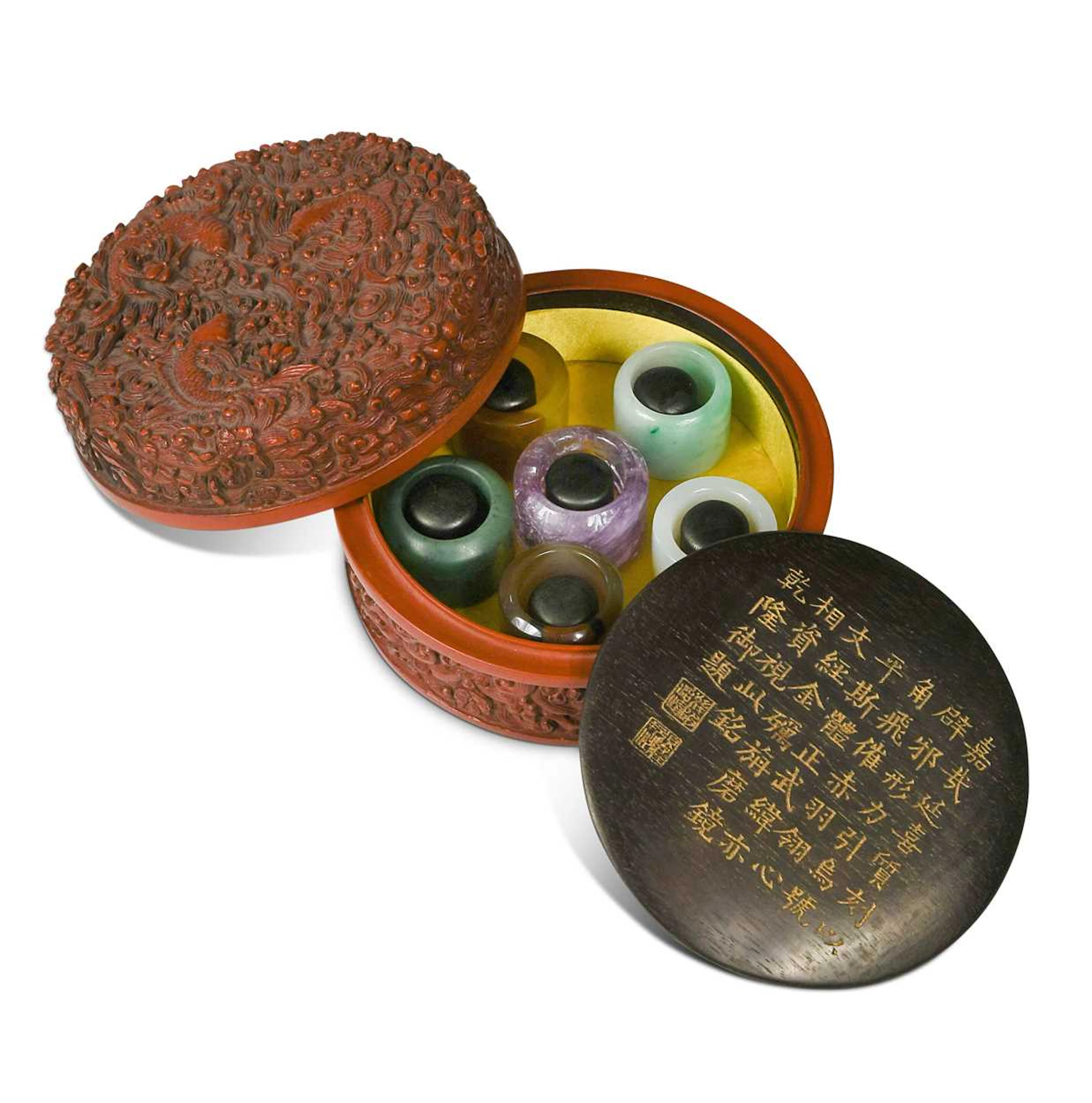 A cinnabar lacquer boxed set of six hardstone archer's rings