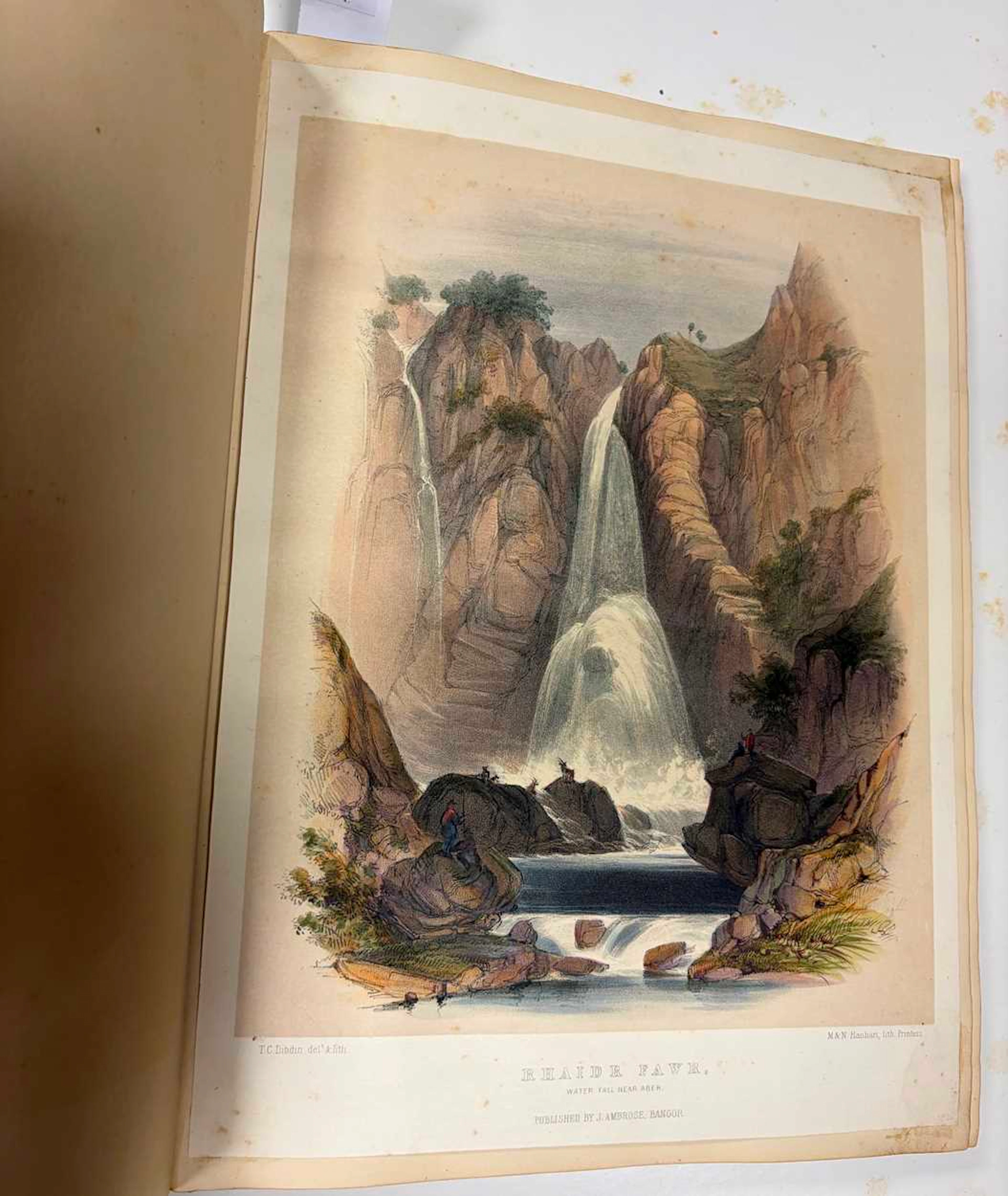 A Victorian linen and leather bound scrap book containing topographical