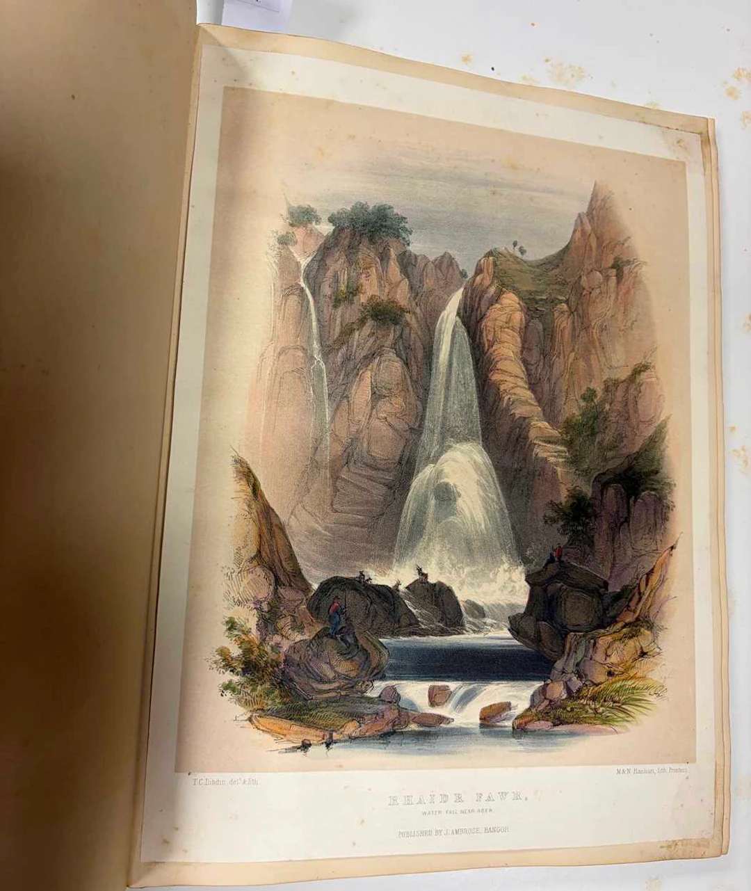 A Victorian linen and leather bound scrap book containing topographical