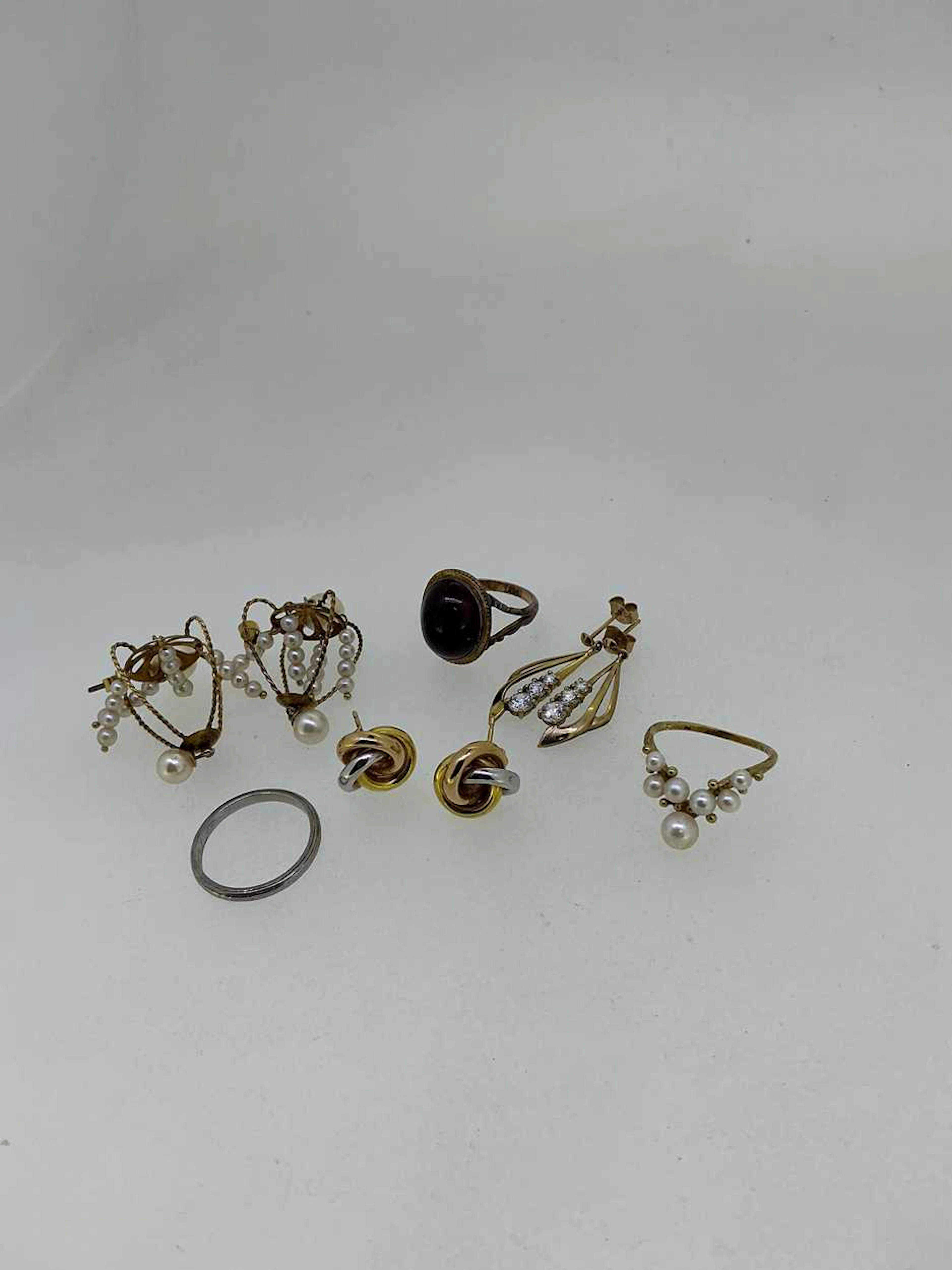 A jewellery box containing a pair of knot style ear studs