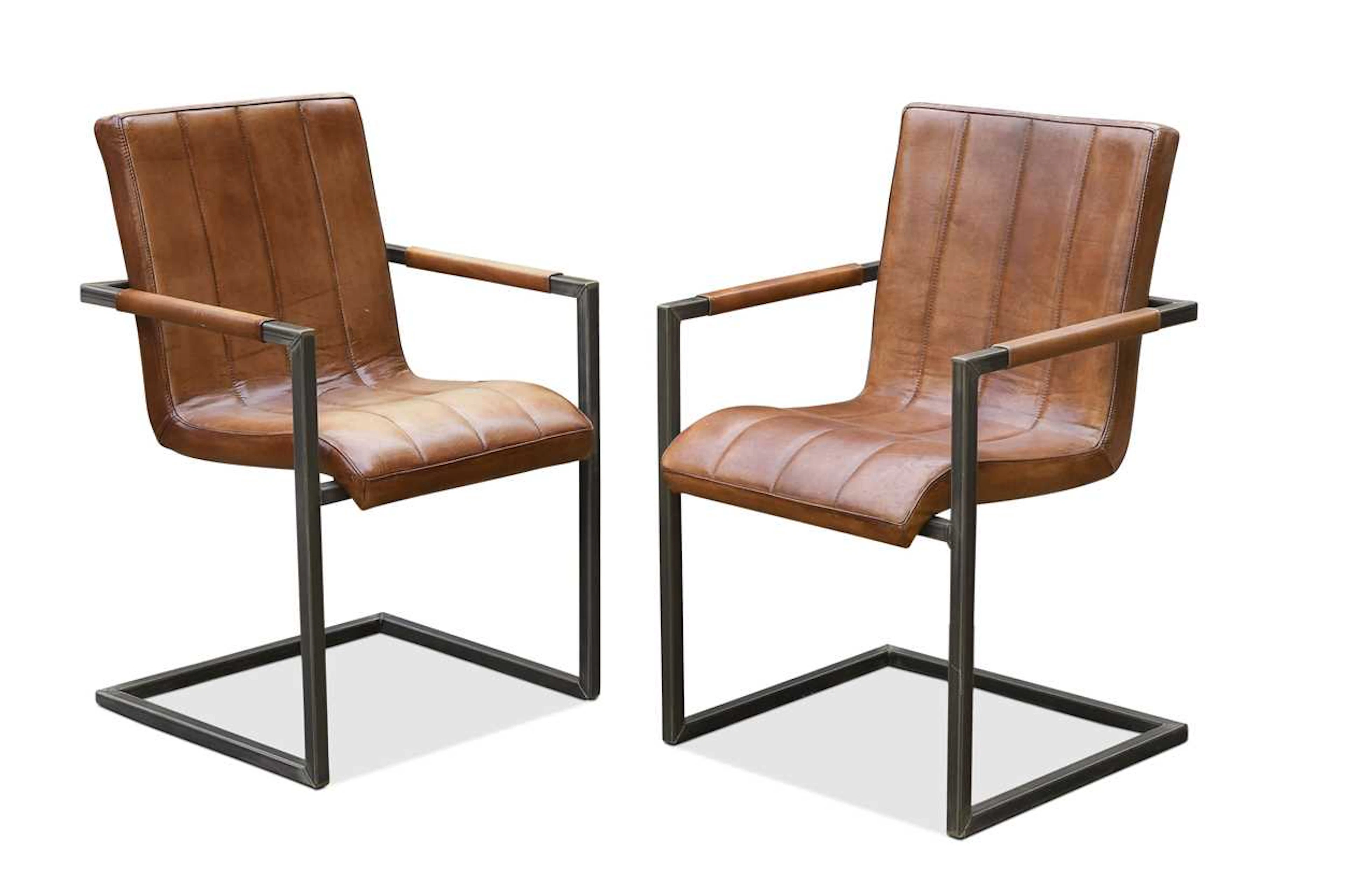 A pair of contemporary leather upholstered cantilever armchairs