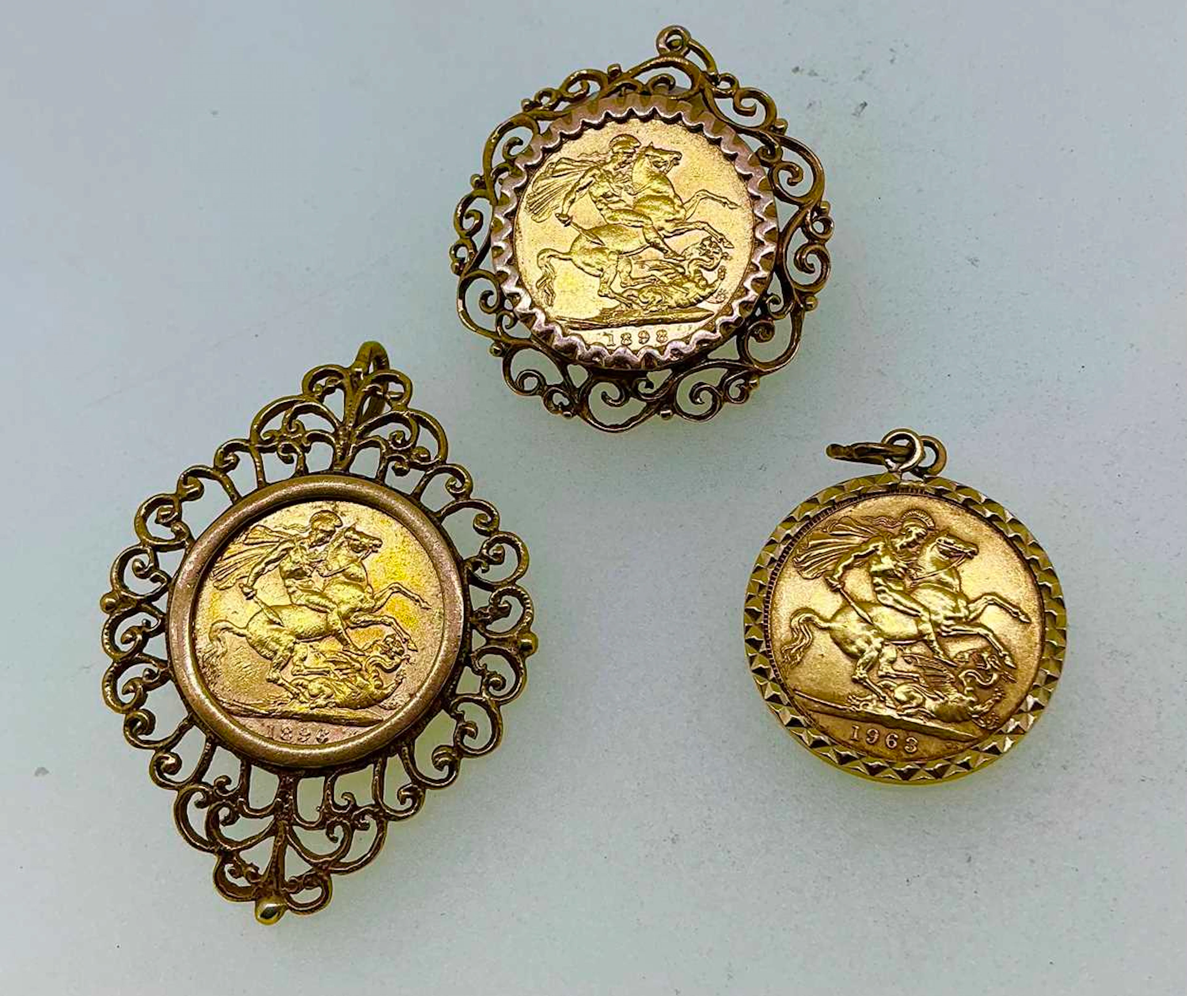 Three full sovereign pendants