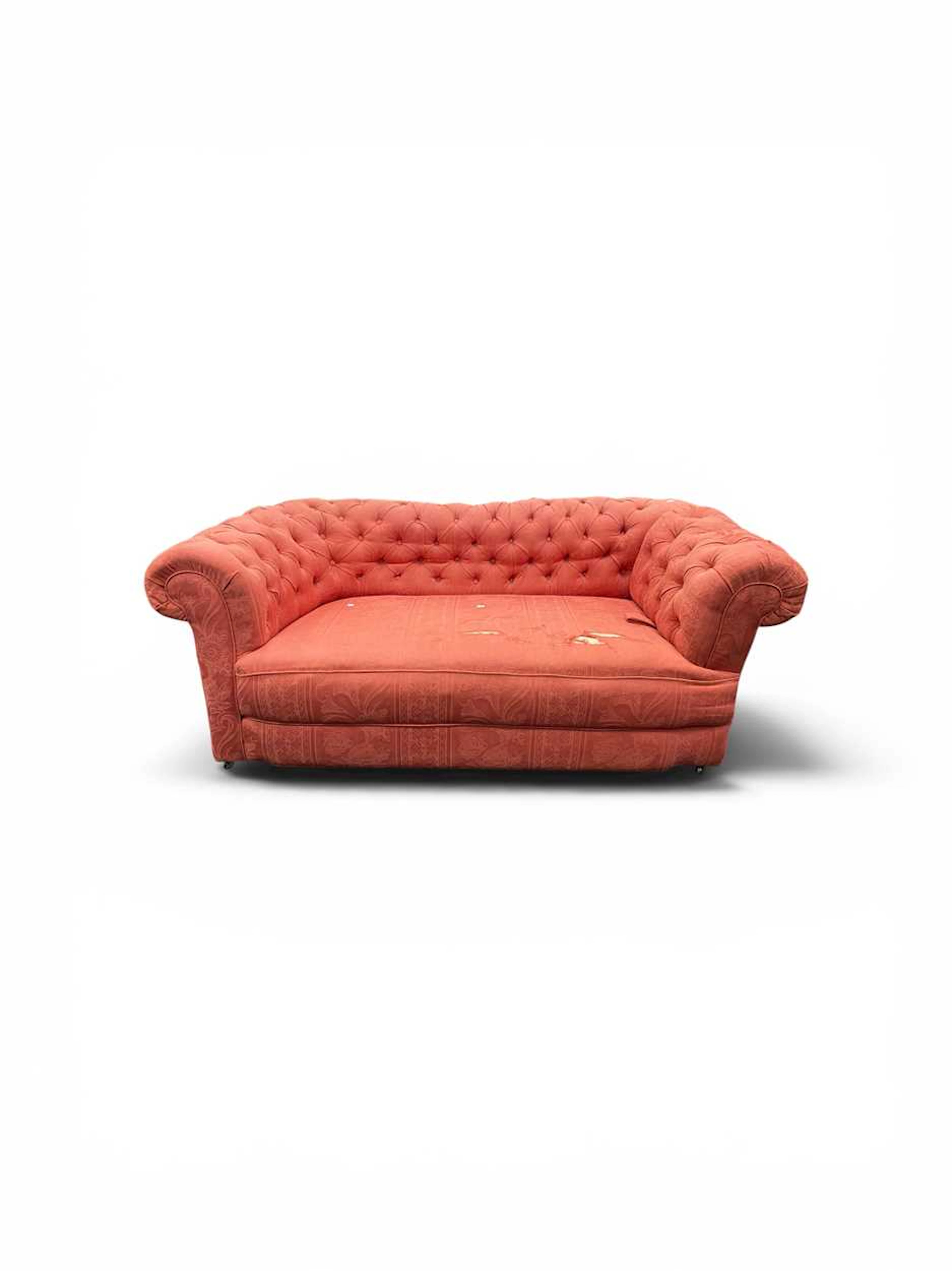 A small two seat Chesterfield sofa