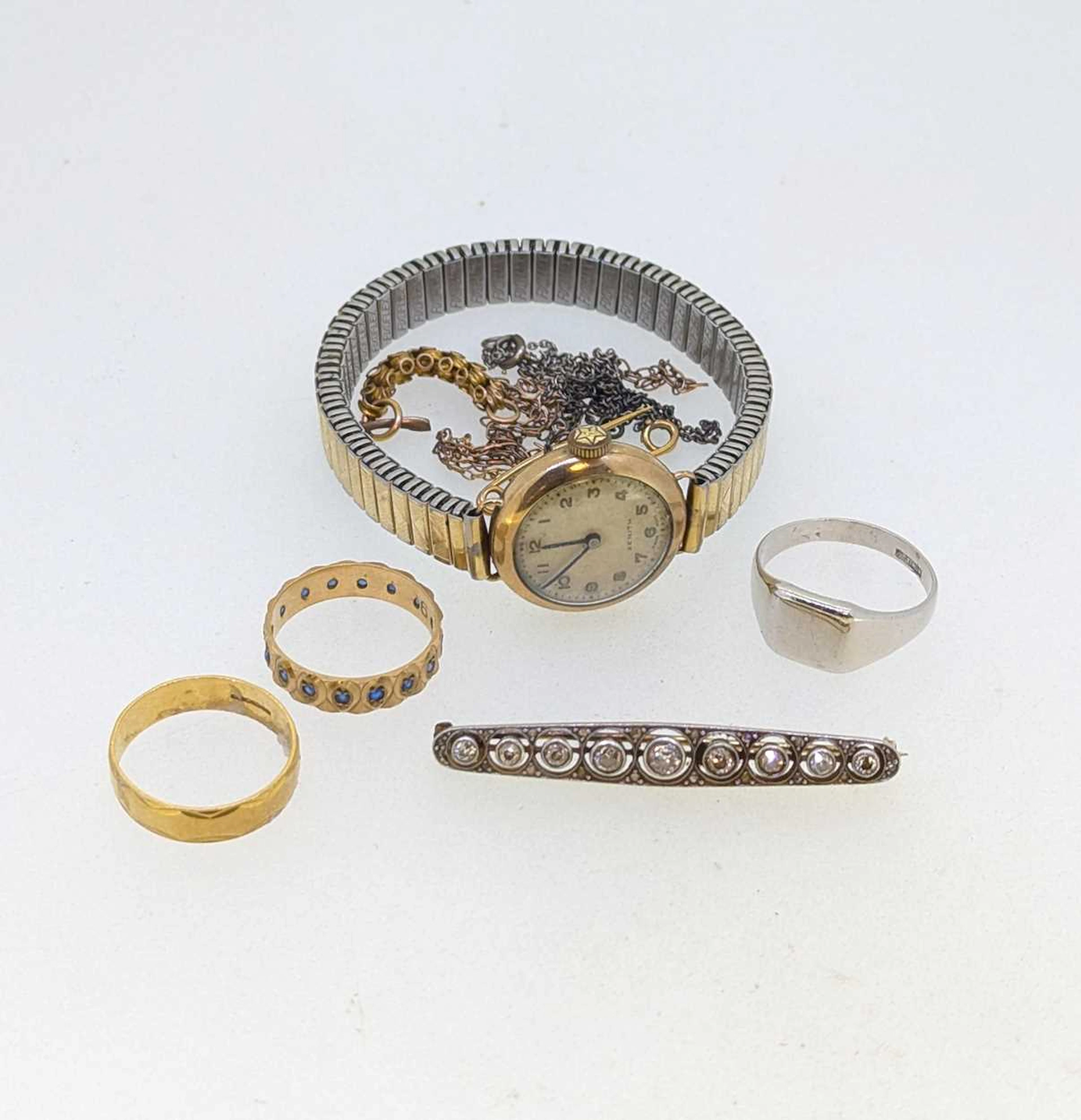 A hallmarked 18ct gold ring and a diamond set brooch...