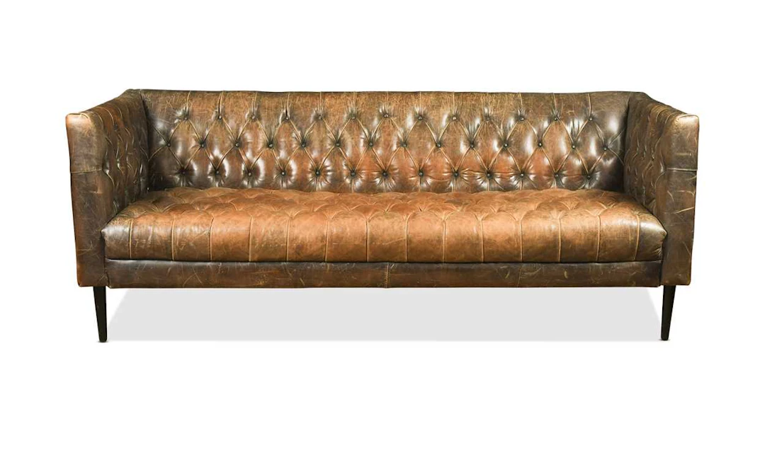 A leather button upholstered three-seat sofa