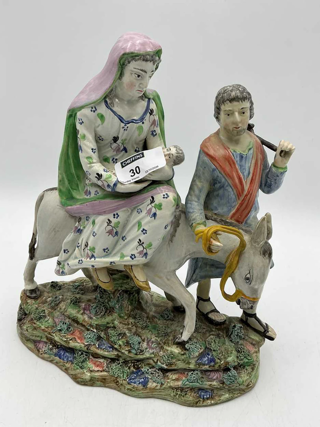 A Staffordshire figure group of Joseph and Mary's flight into Egypt 27cms