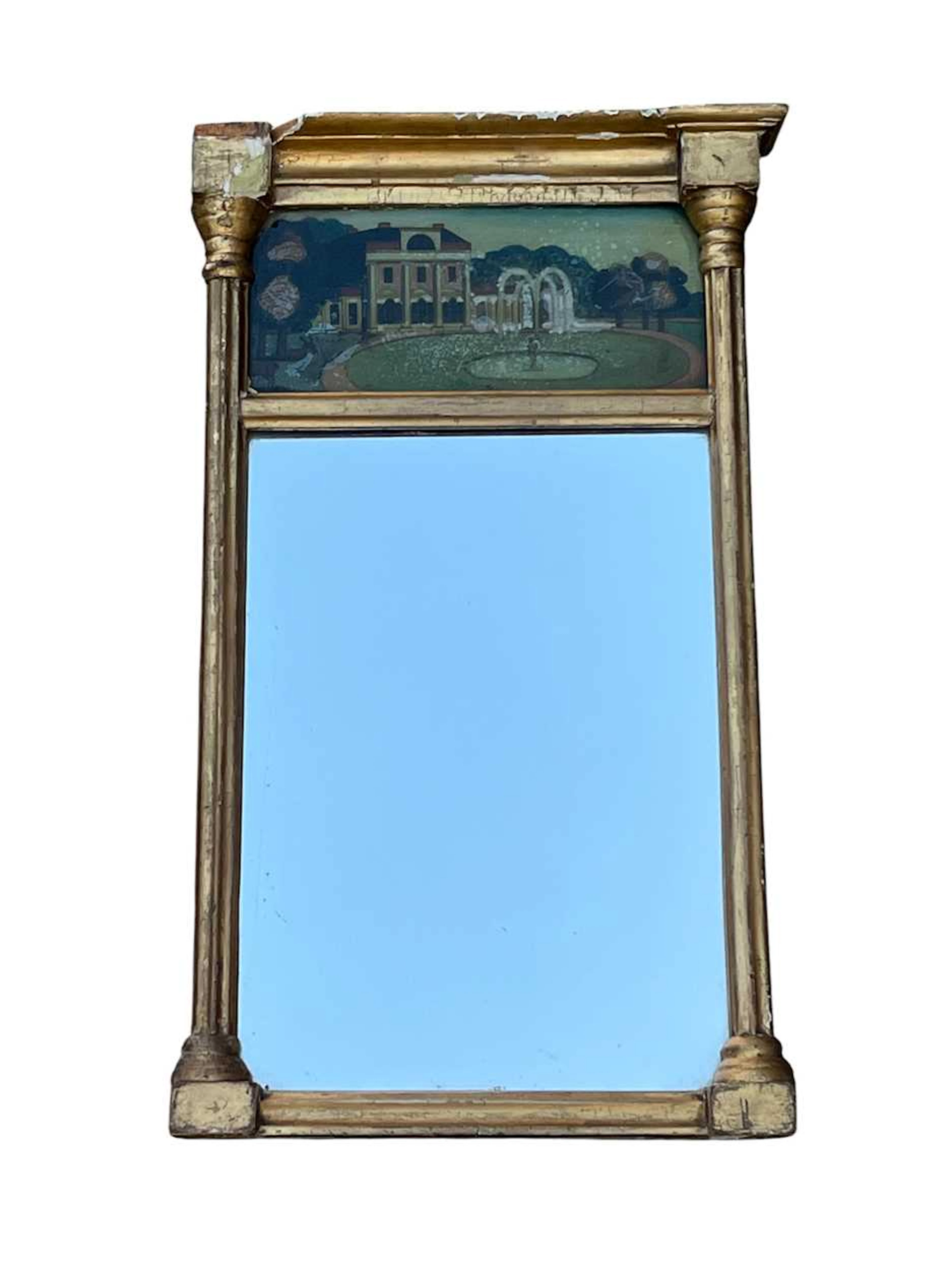 A 19th century giltwood pier mirror with a verre eglomise...