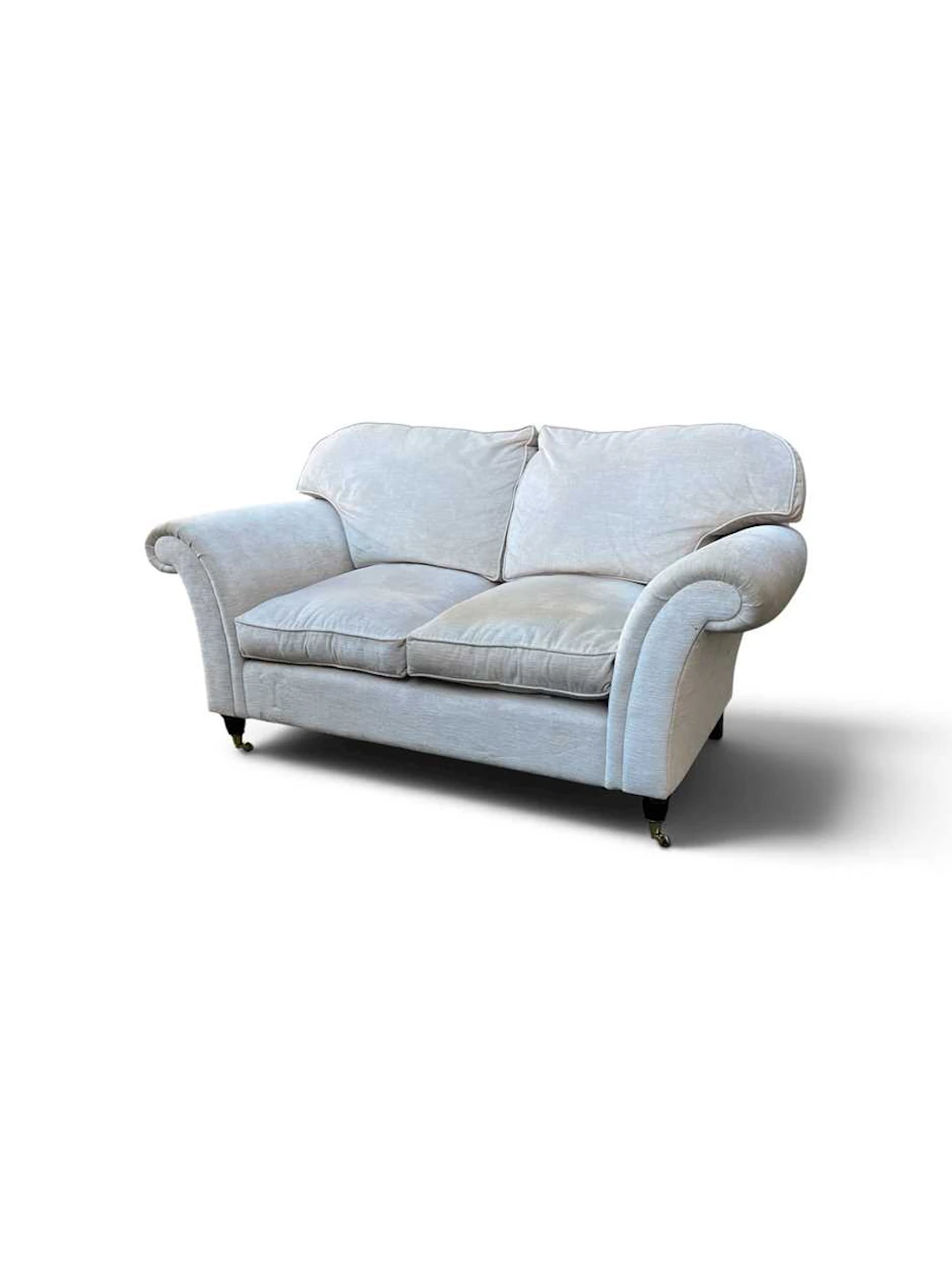 An upholstered armchair and two seat sofa retailed by Laura Ashley