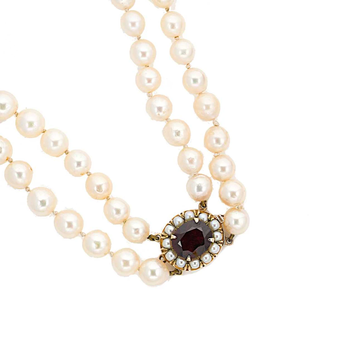 A double row cultured pearl necklace with a garnet clasp