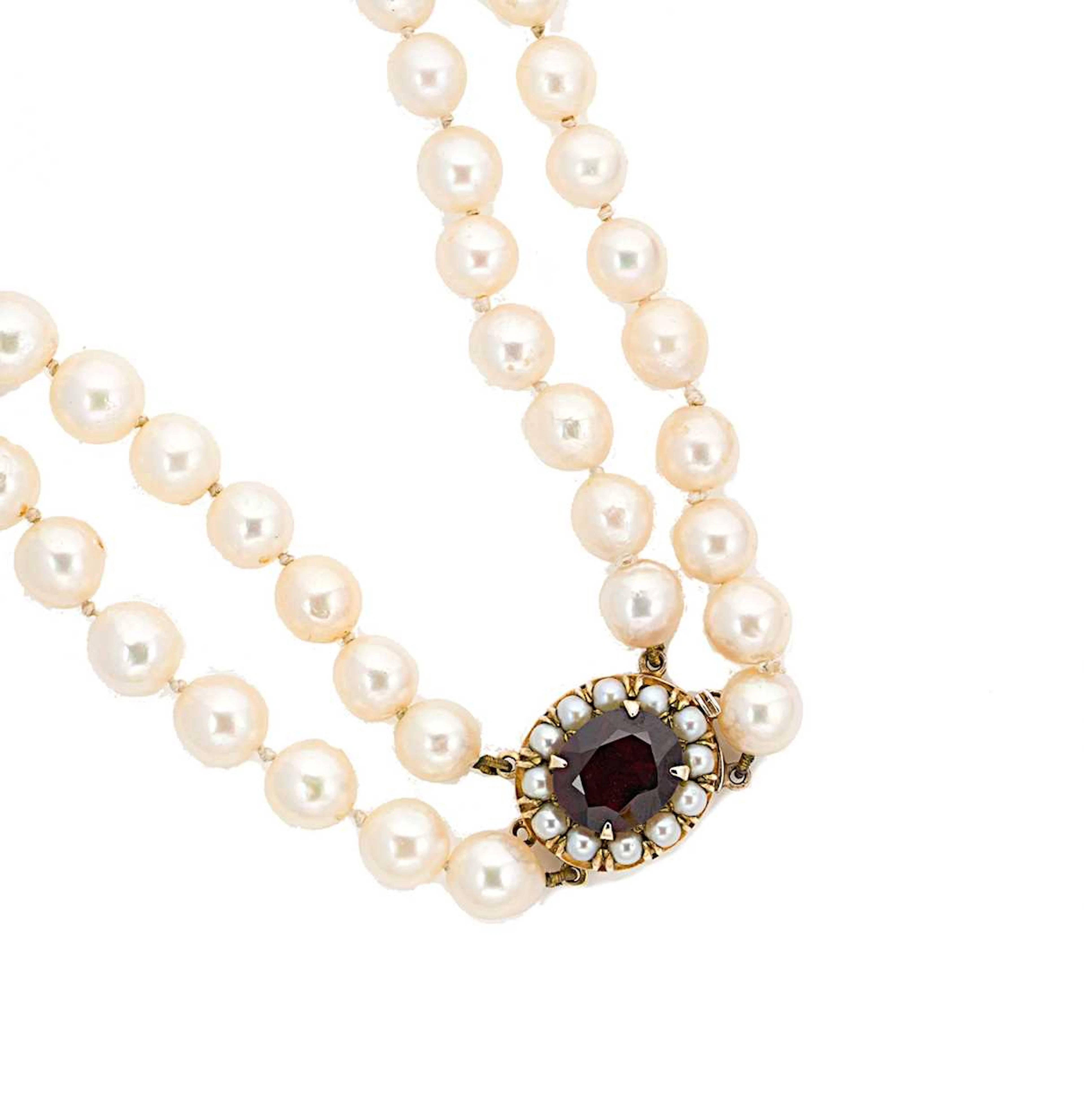 A double row cultured pearl necklace with a garnet clasp