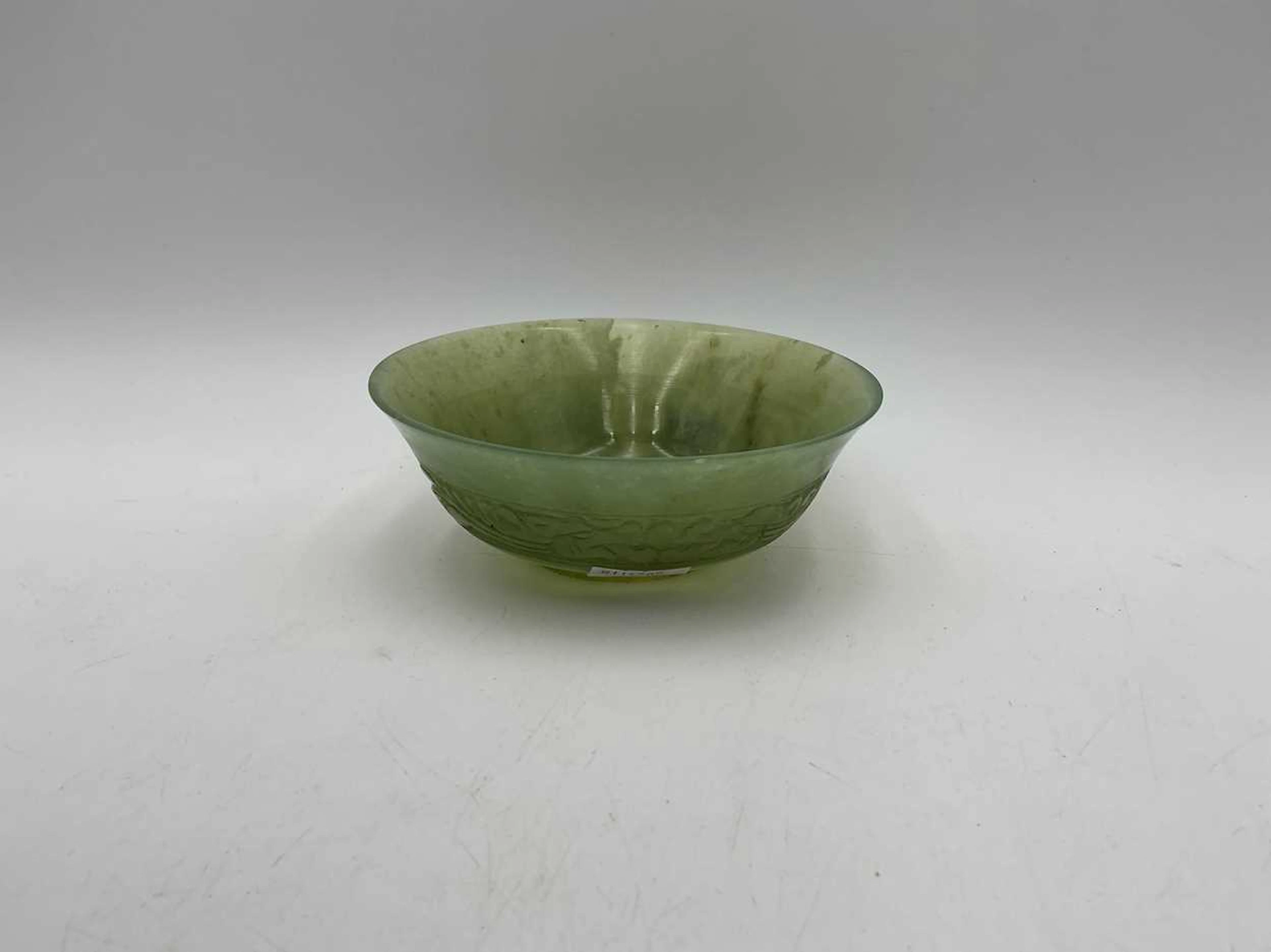 A small jade jade bowl with carved floral frieze 5 x 13cm