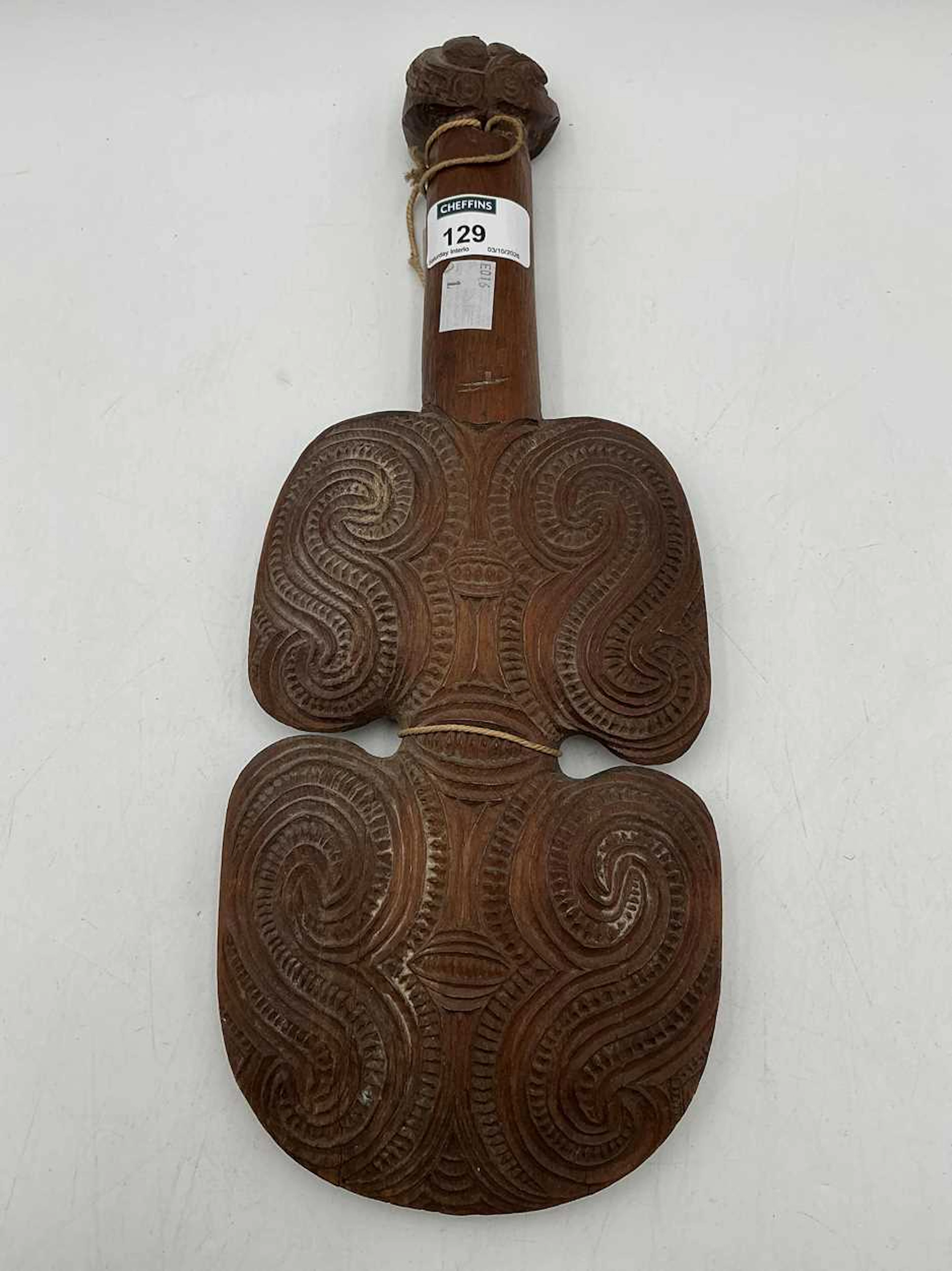 A Maori hand club with carved decoration 36cm