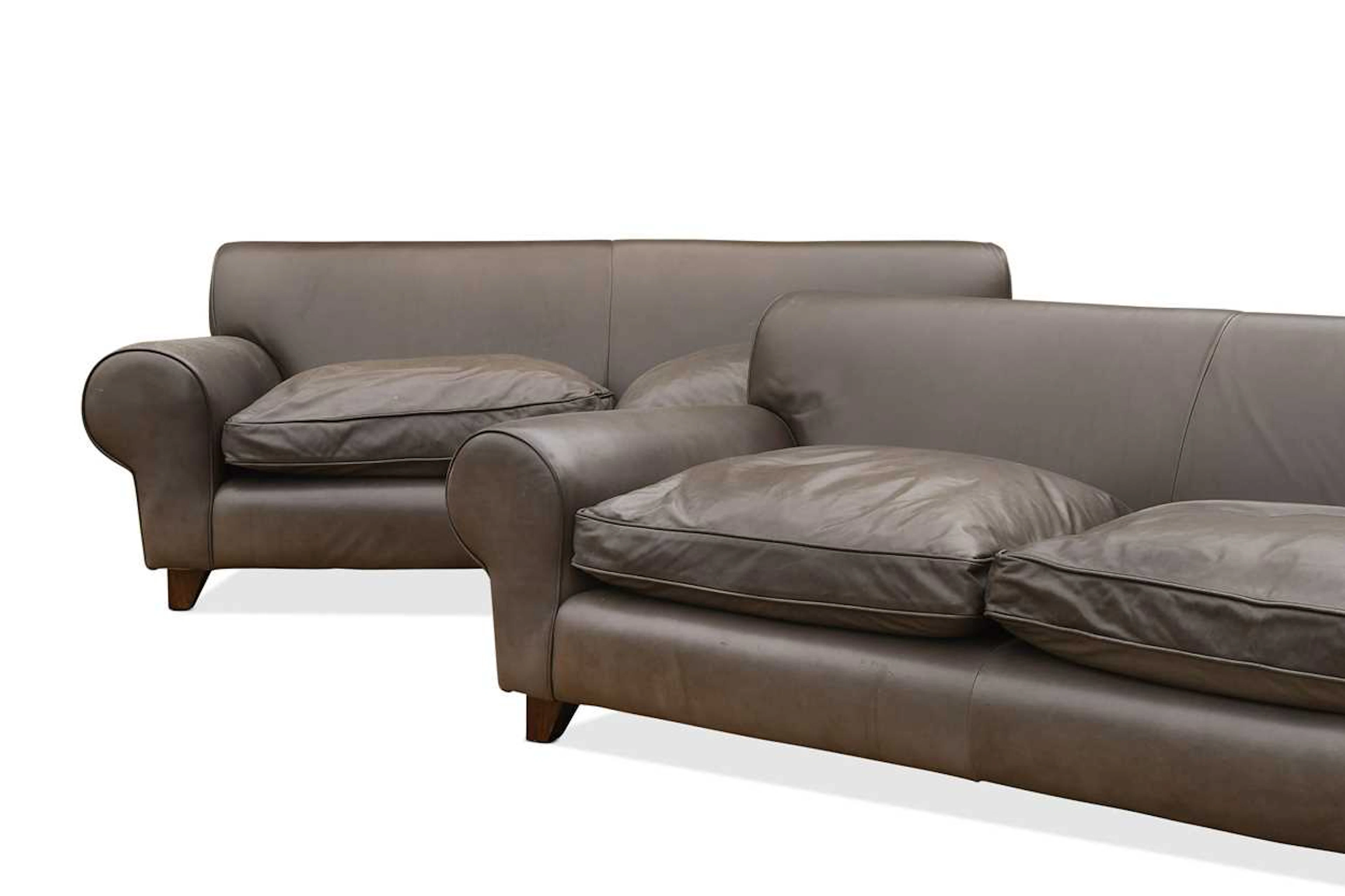 A pair of large brown leather 'Bertie' sofas, retailed by Liberty & Co.