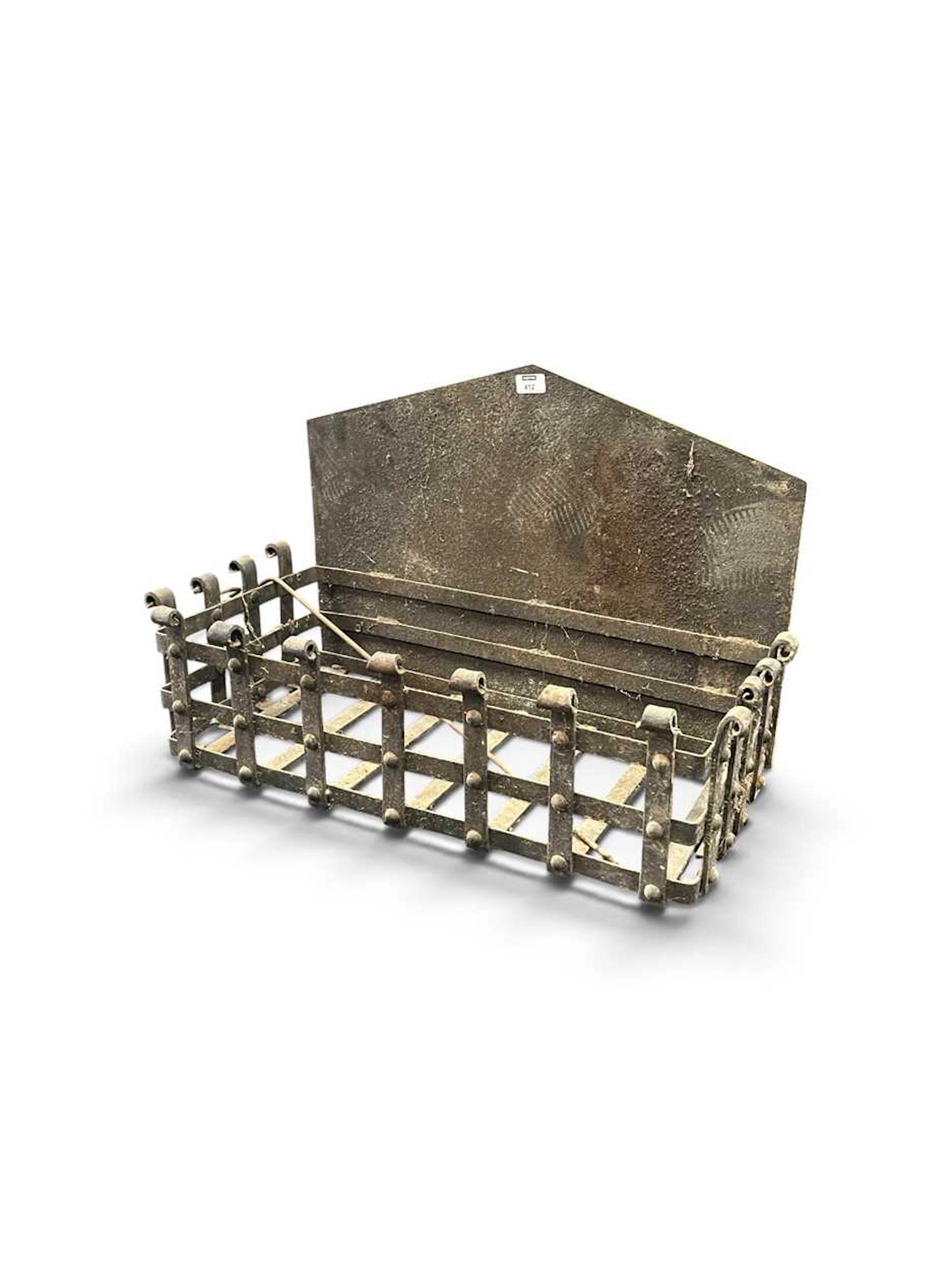 A large cast iron grate with integral back plate