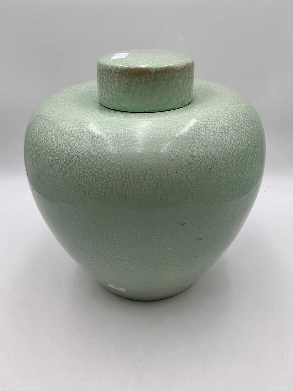 A very large lidded ginger jar of celadon colour with...