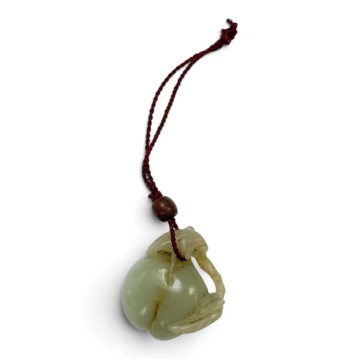 A Chinese carved celadon jade peach pendant, Qing Dynasty, 18th or 19th century