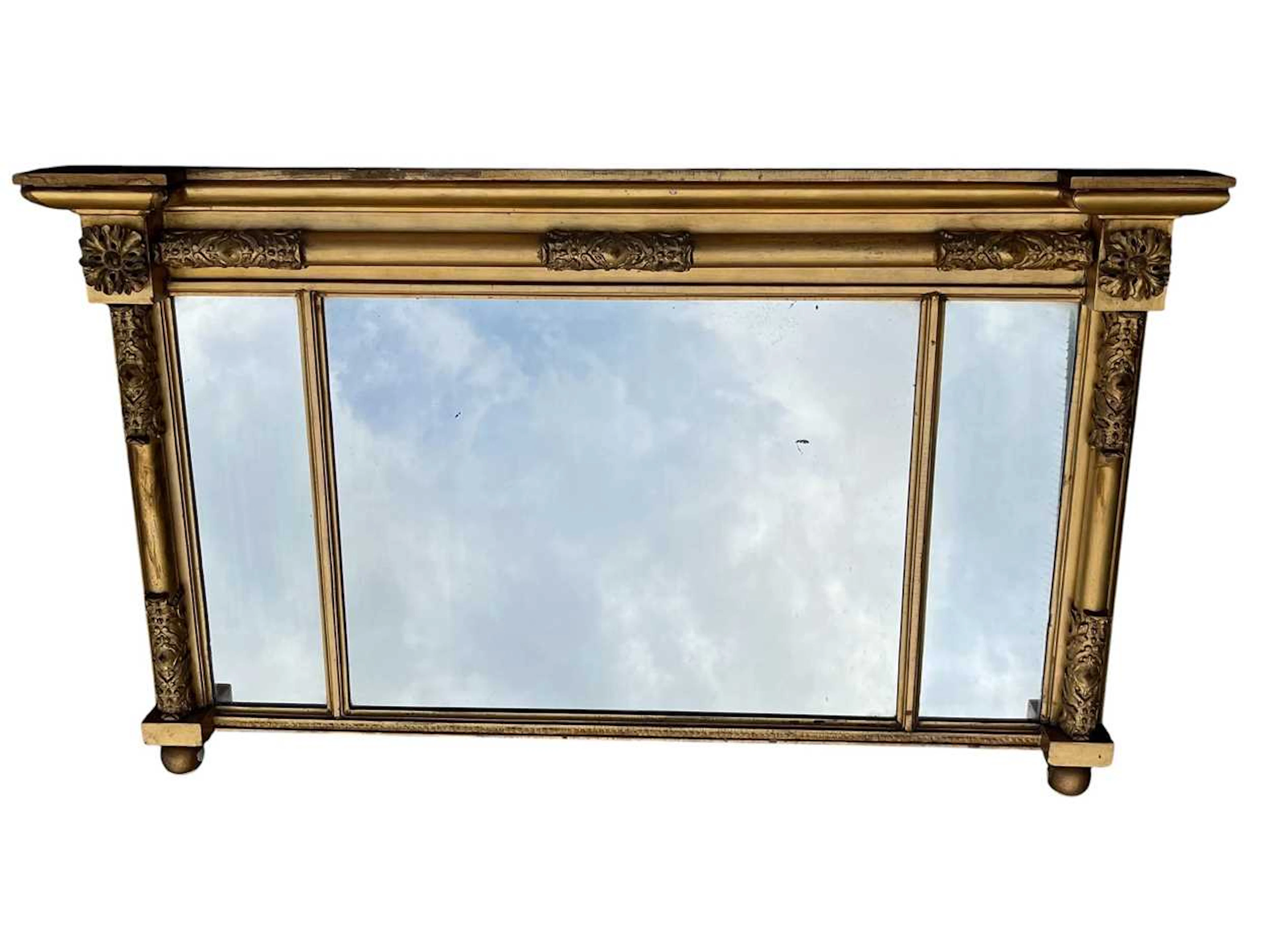 A gilt framed triple plate overmantel mirror