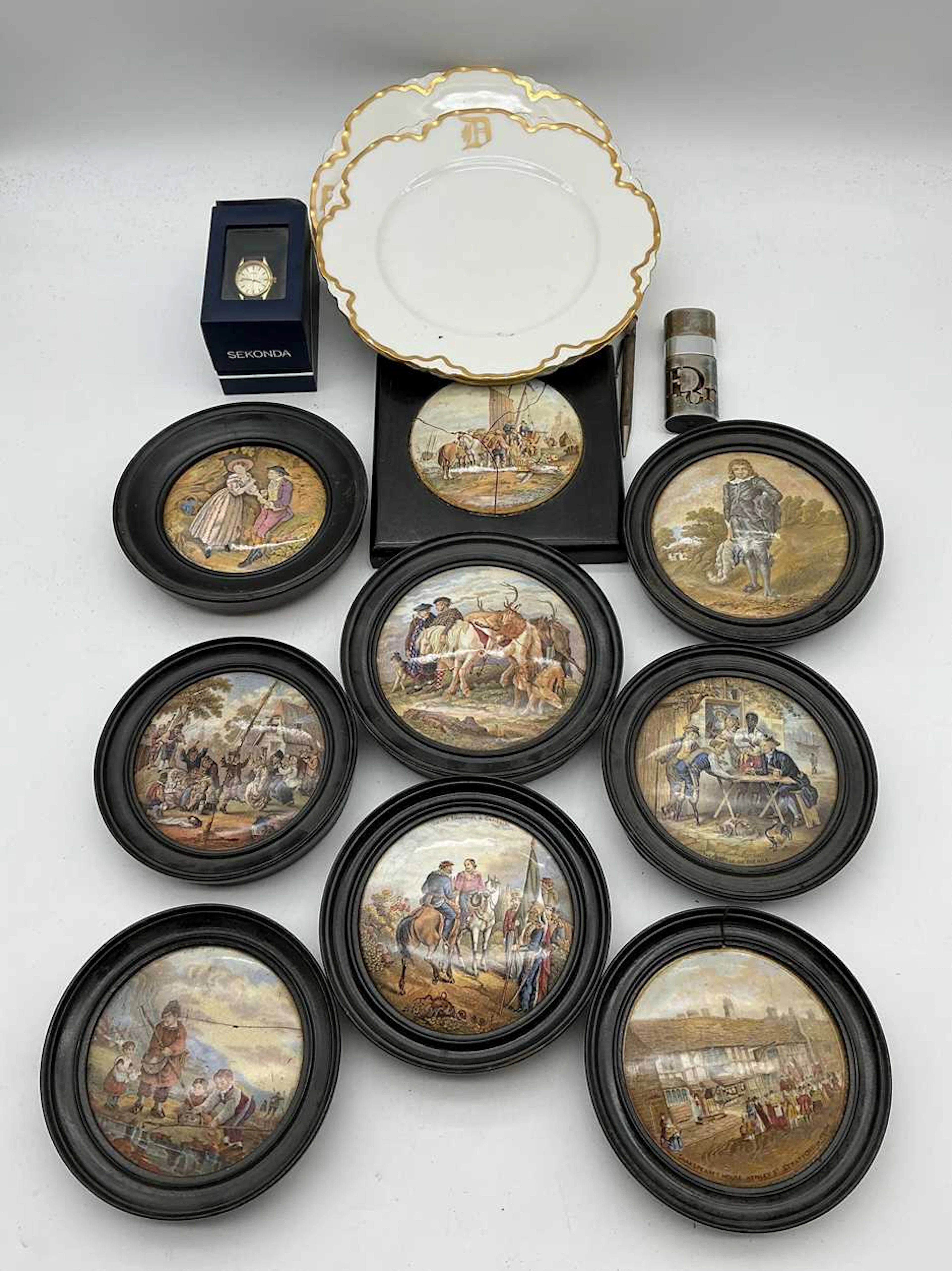 A collection of framed pot lids