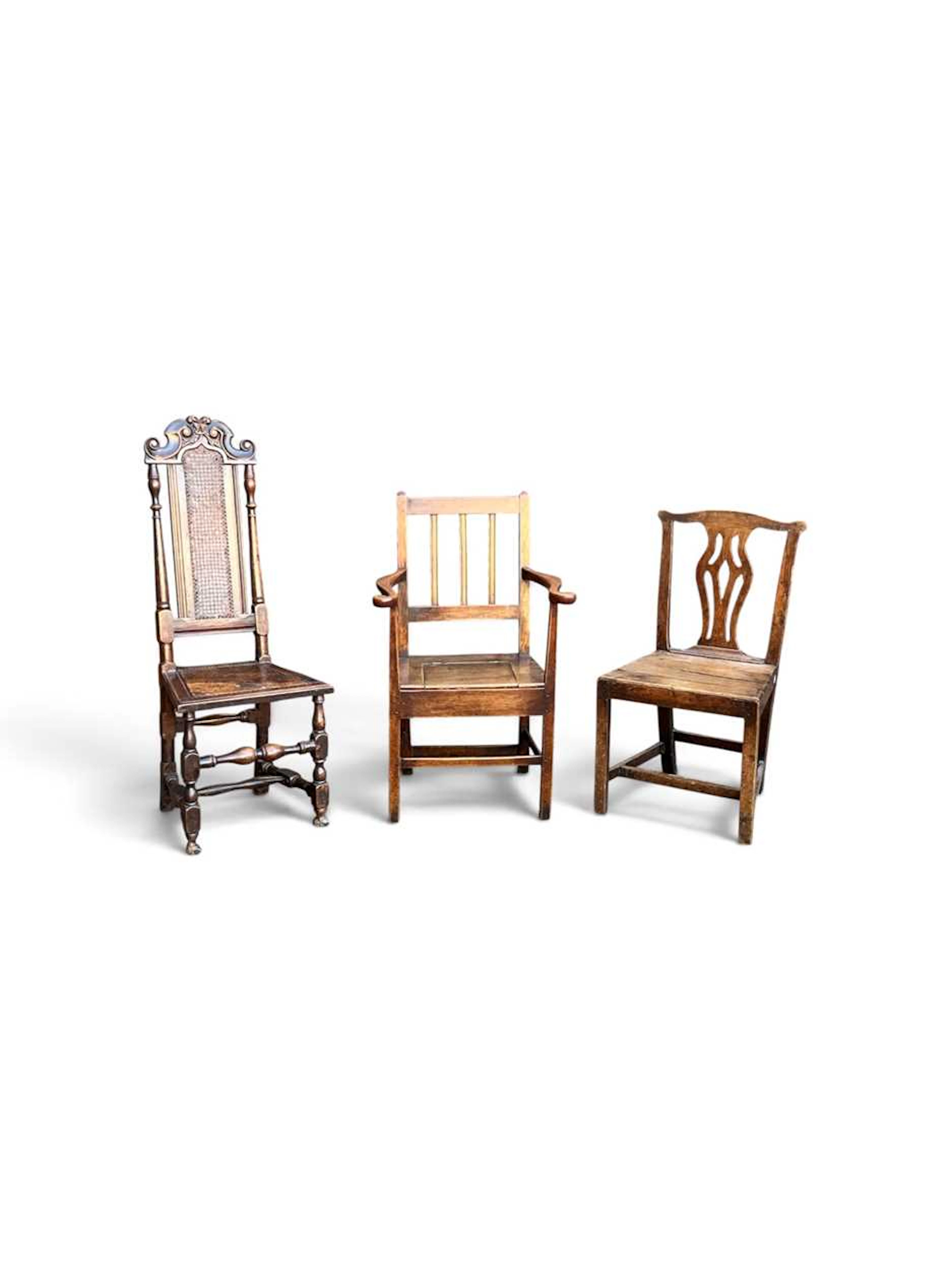 A George III elm stick back armchair with adapted commode seat