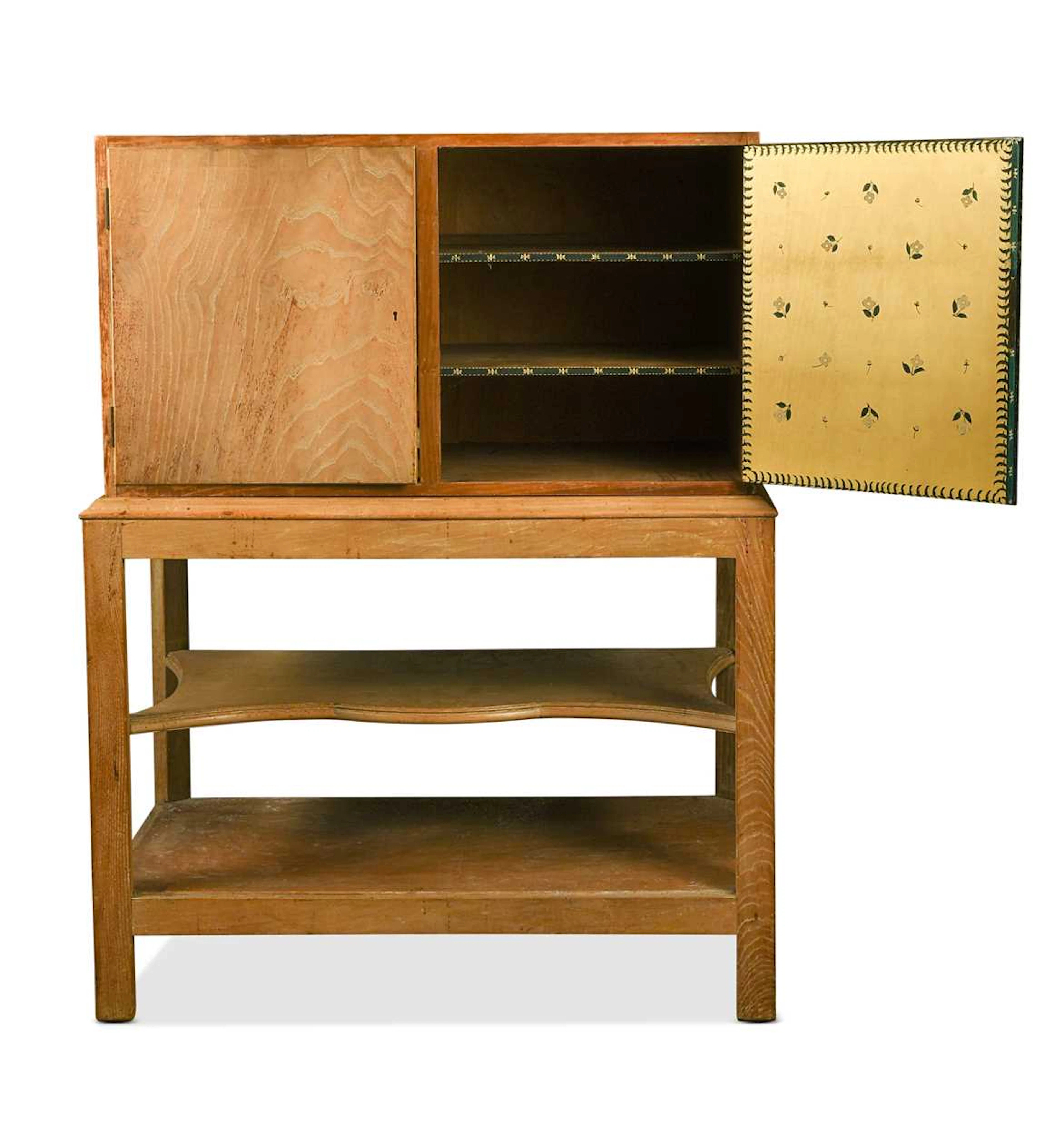 A Cotswold School limed oak cabinet on stand, internally painted by