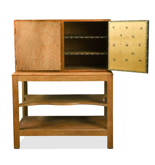A Cotswold School limed oak cabinet on stand, internally painted by