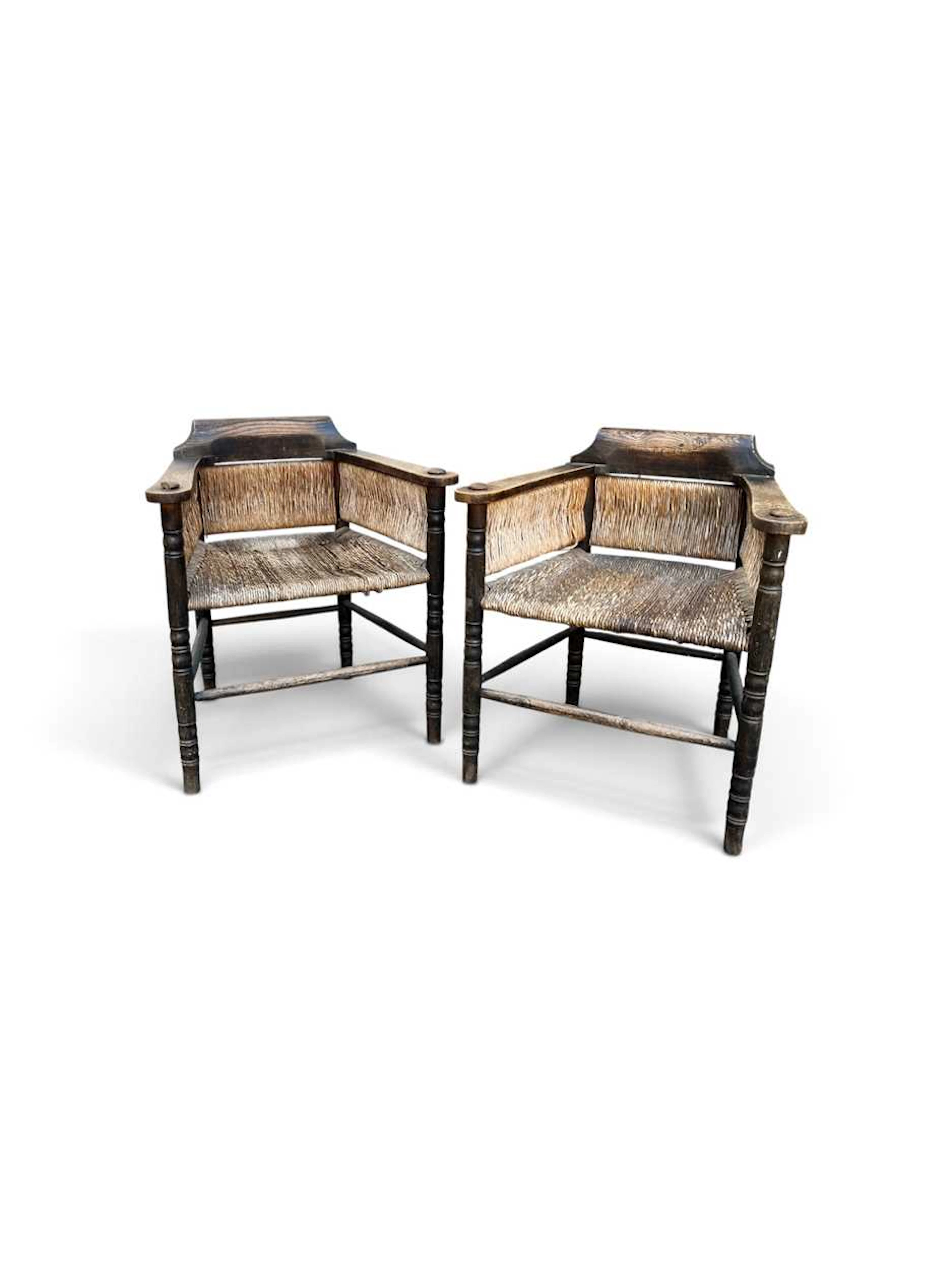 A unusual pair of Arts & Crafts rush seated chairs