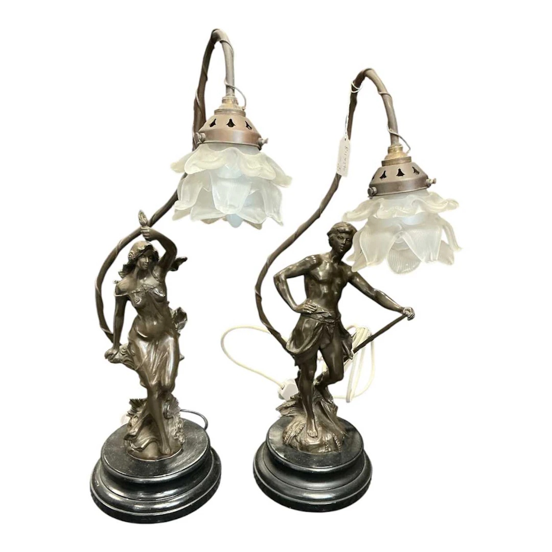A pair of Art Nouveau style bronzed figural table lamps with petal shape shades