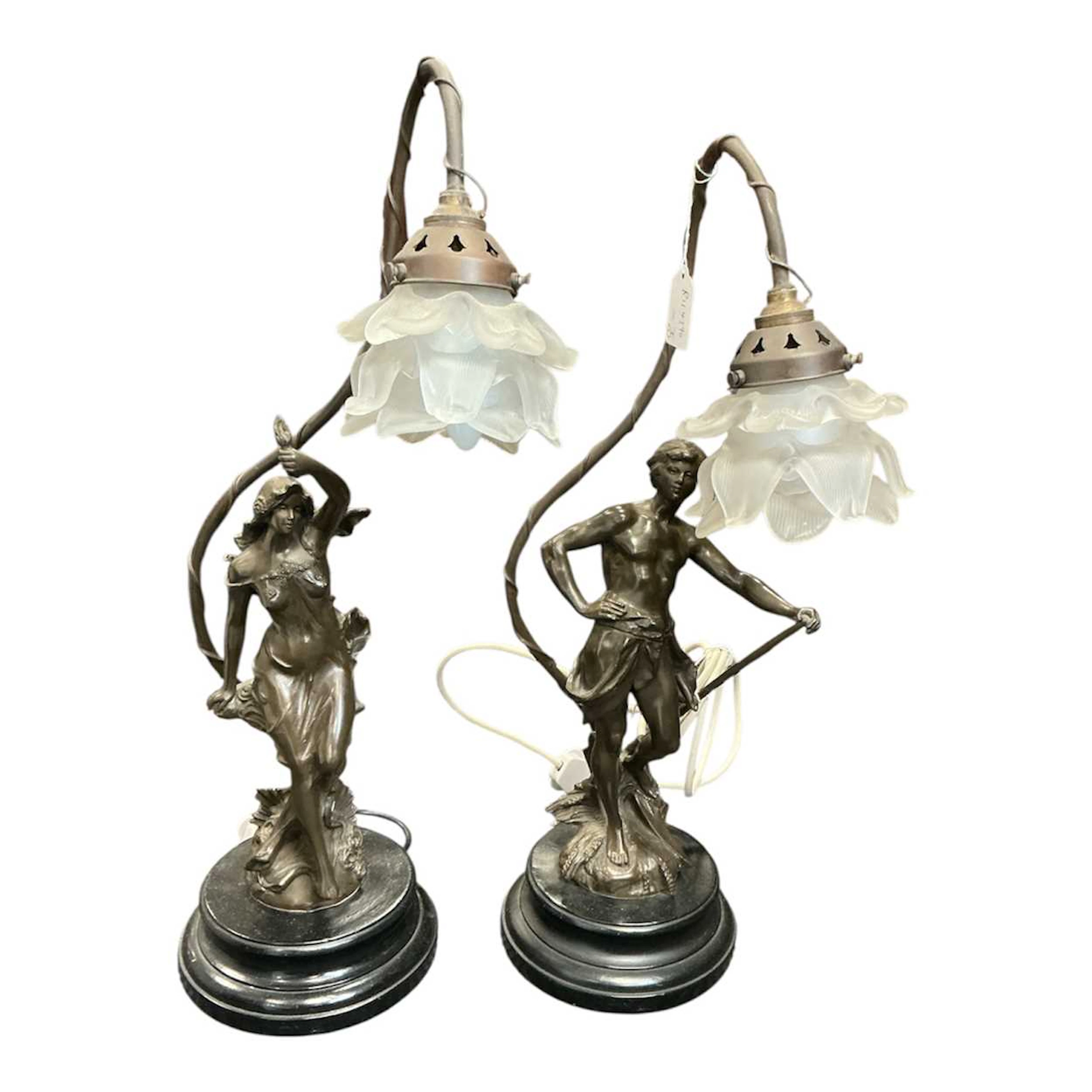 A pair of Art Nouveau style bronzed figural table lamps with petal shape shades