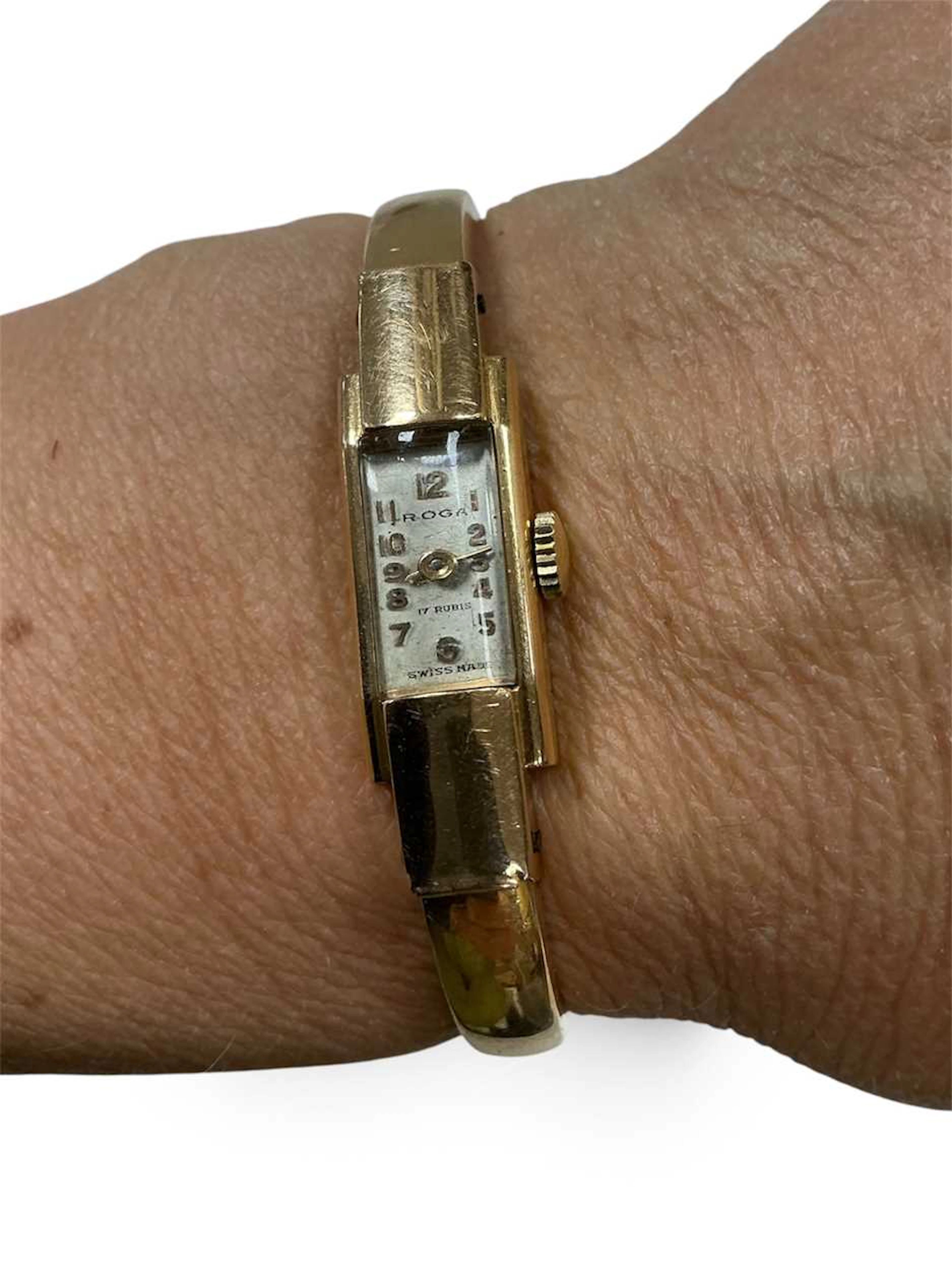Roga - An 18ct gold mechanical wristwatch with a hinged bangle style bracelet