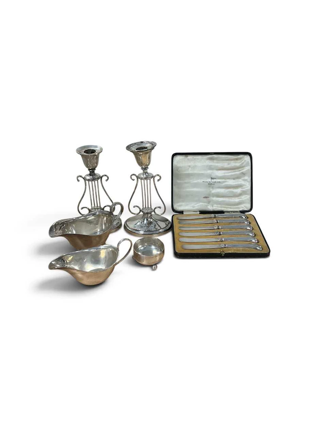A pair of plated candlesticks in the form of a lyre