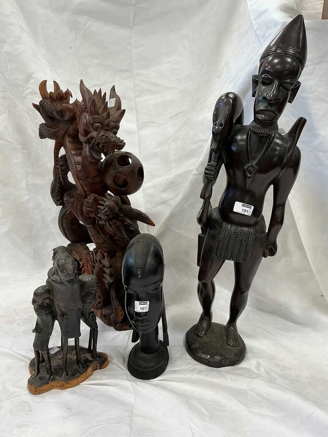 3 African carved wood figures with Far Eastern carved Dragon ornament