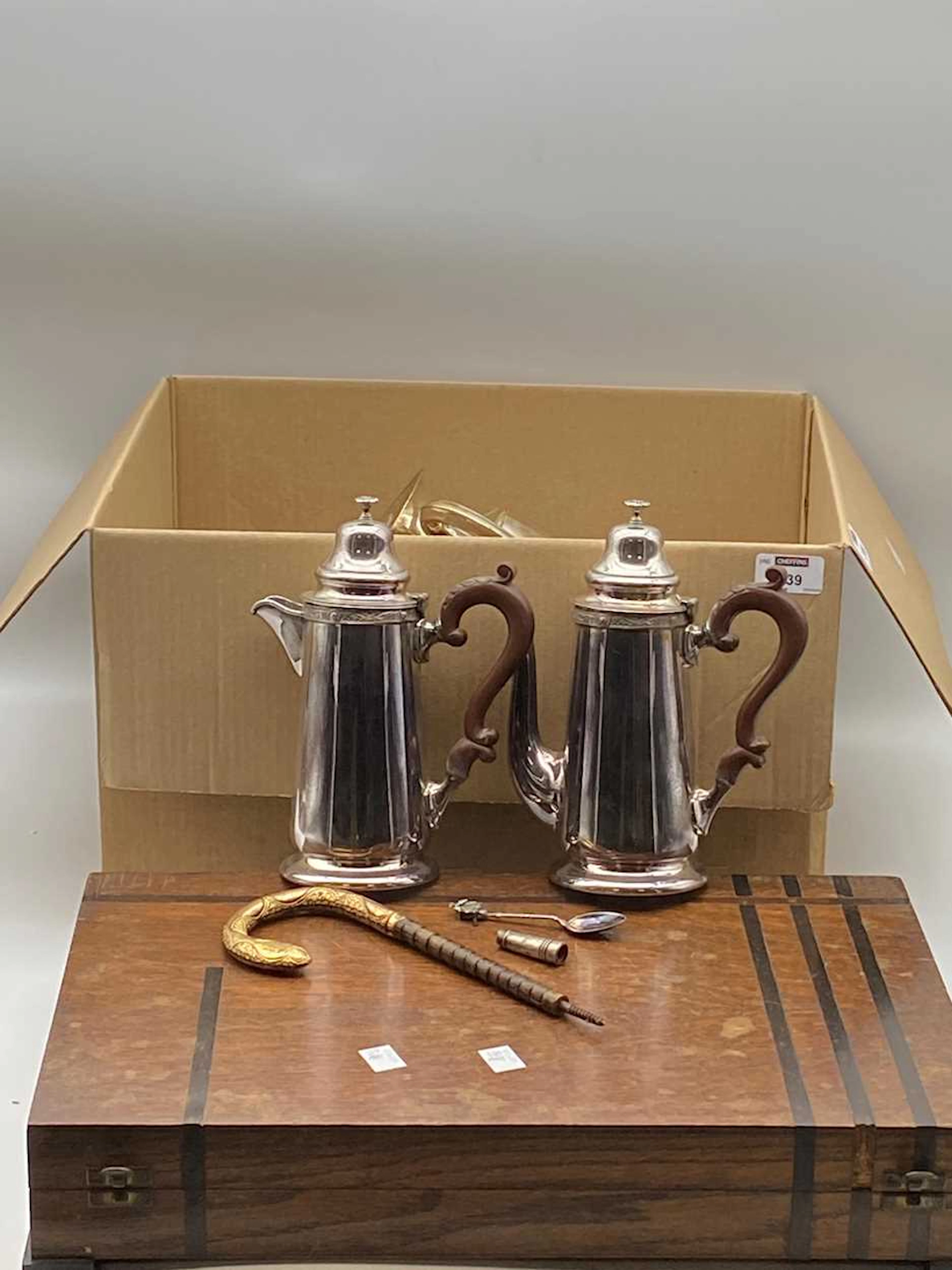 A box of assorted silver plated items