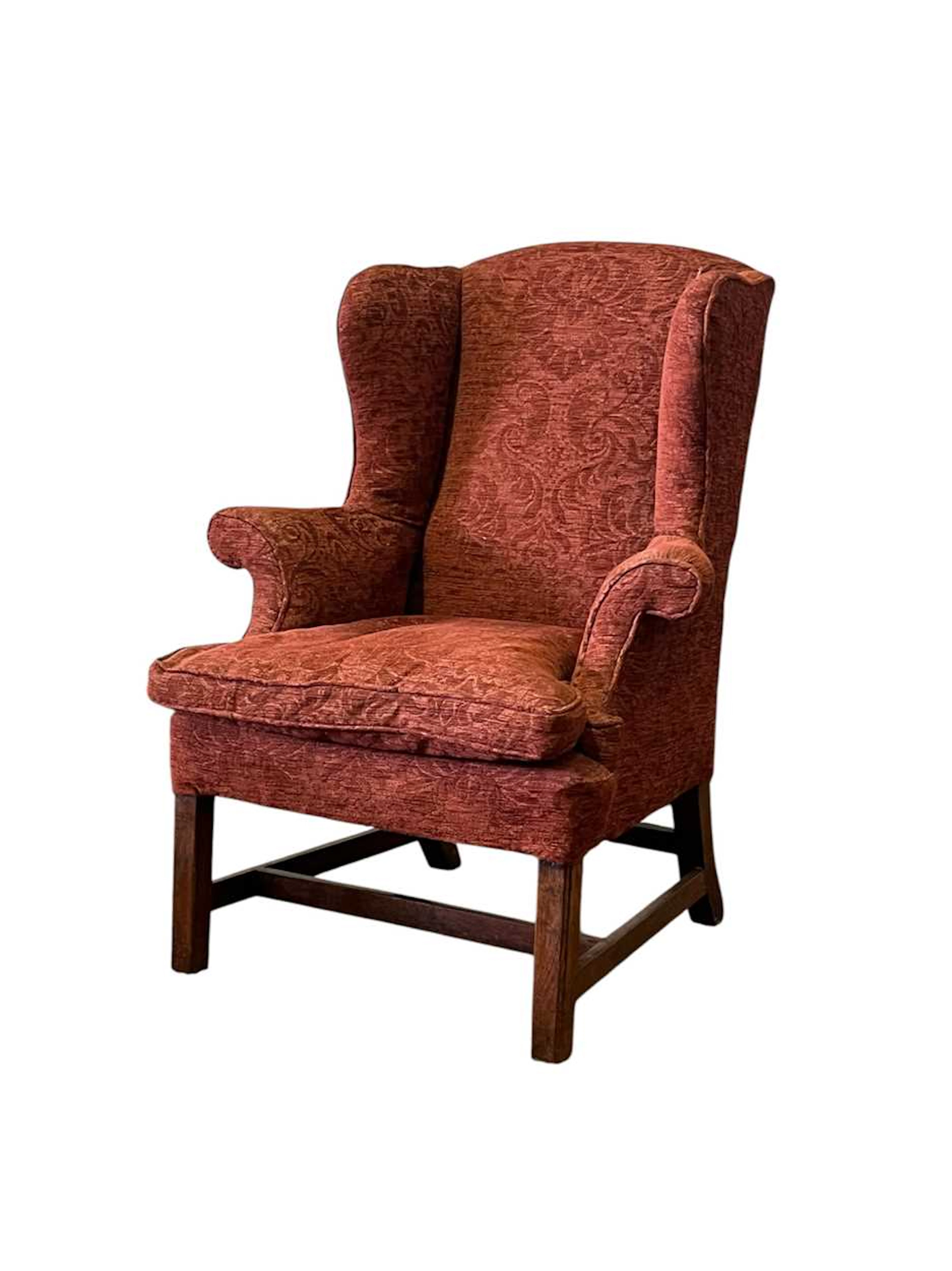 A George III style mahogany wingback armchair