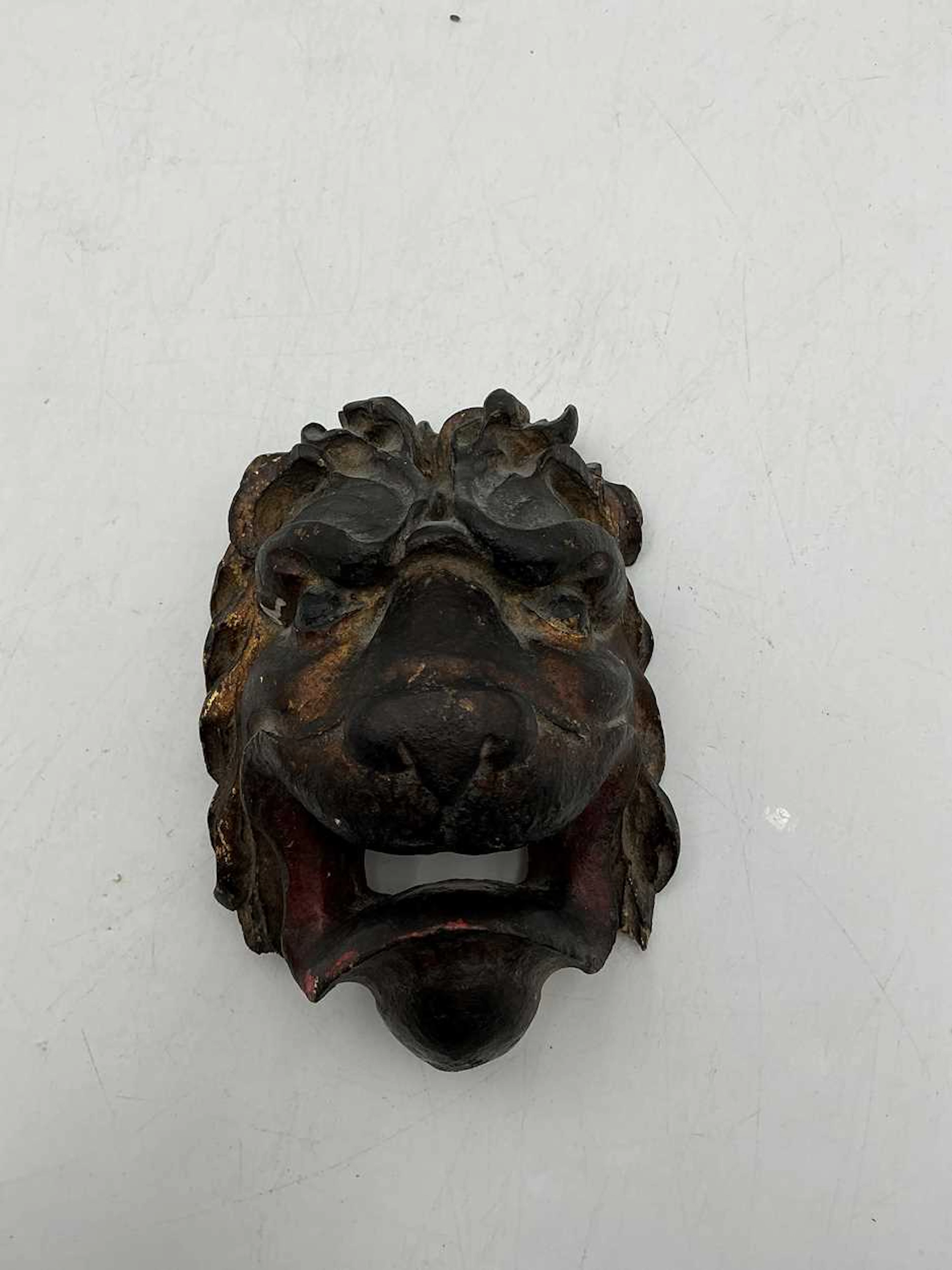 A carved wood and gessoed lion head