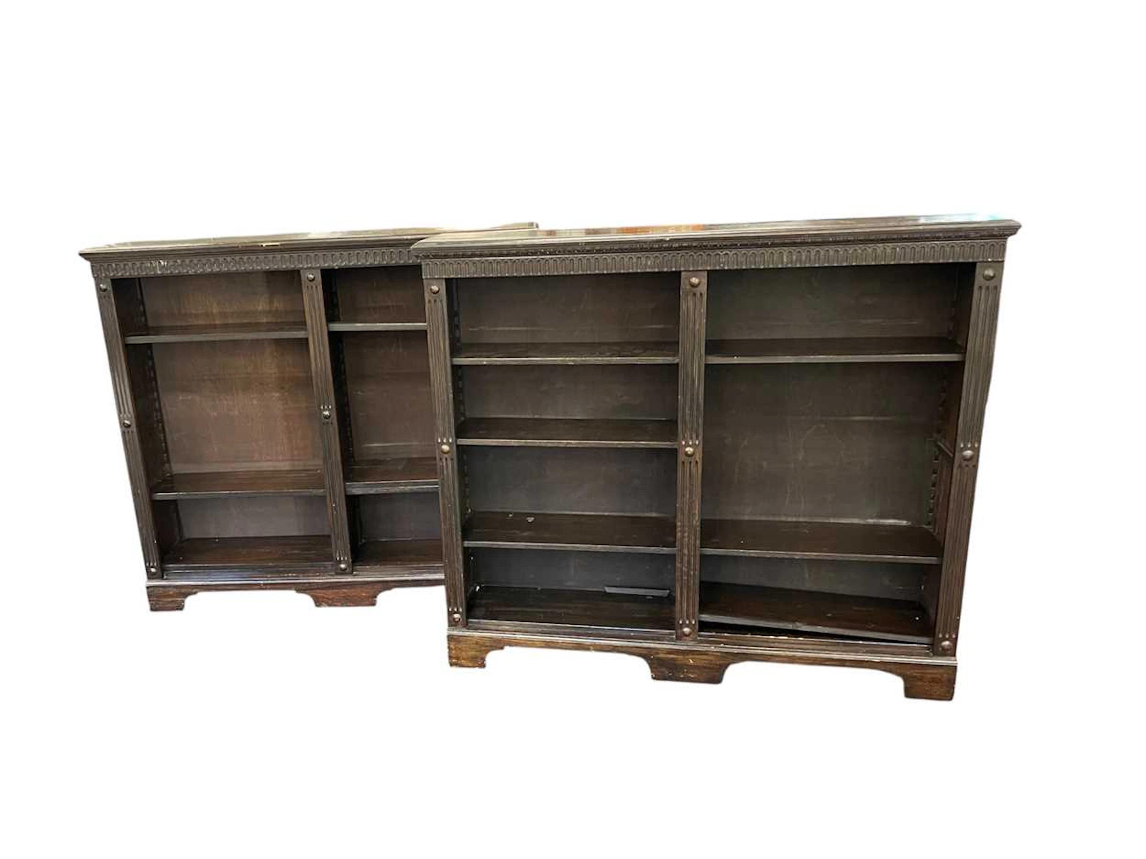 A pair of carved oak open bookcases