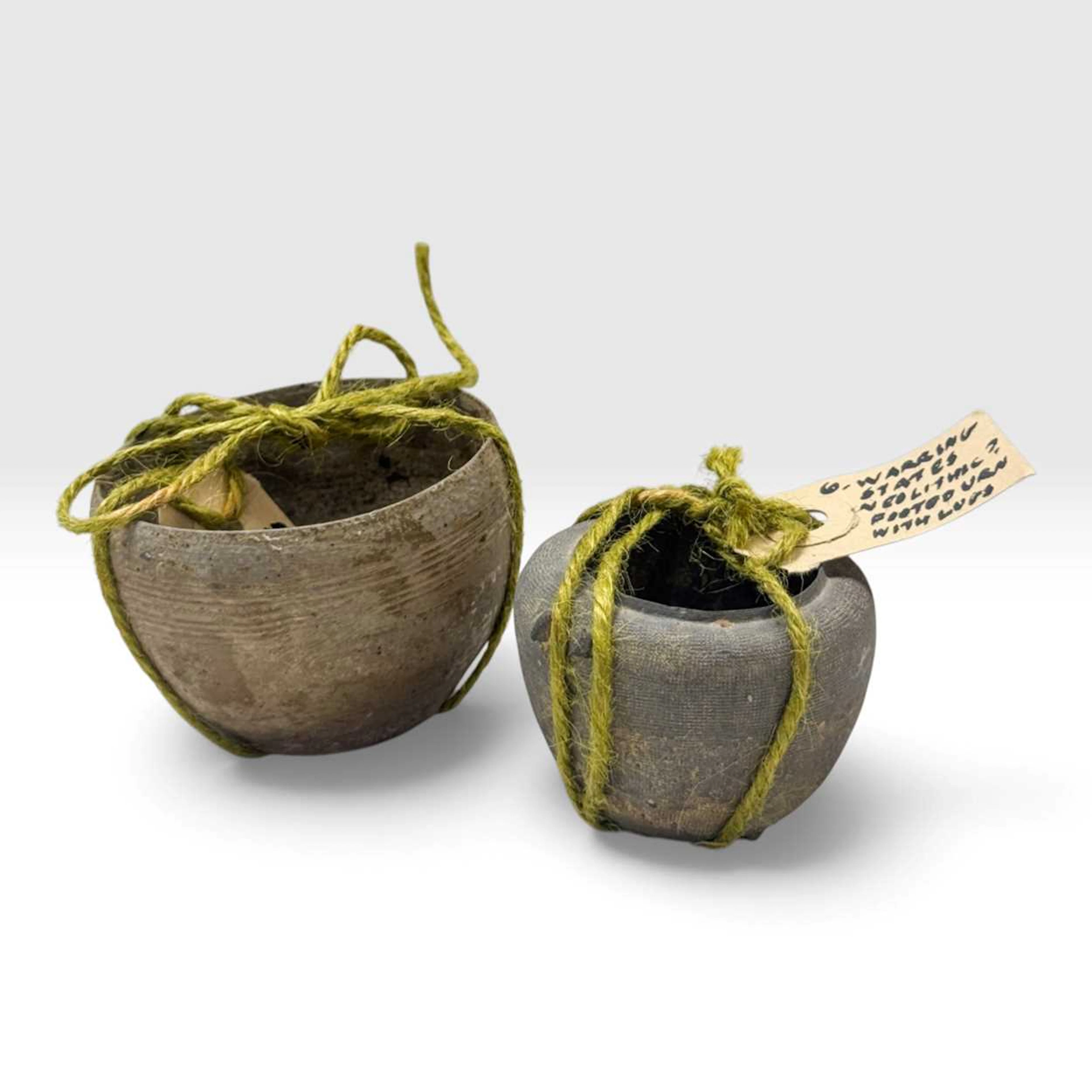 A Chinese grey pottery footed urn, Warring States (c 475- 221BC)